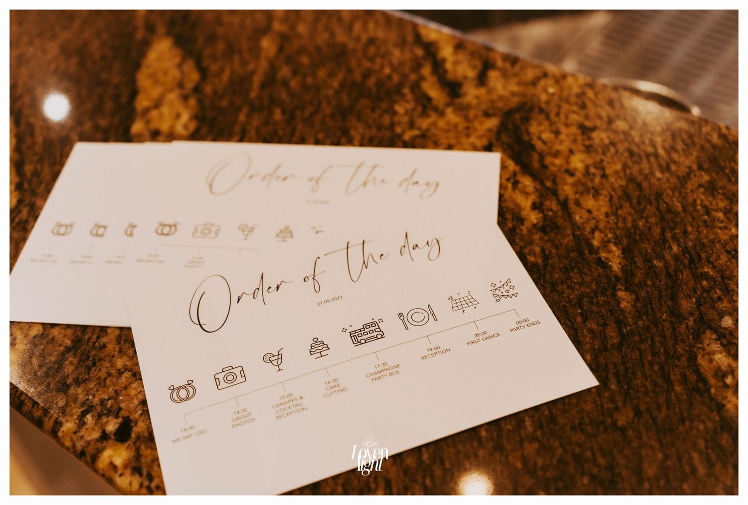 Wedding order of service program cards with icons displayed on a textured surface.