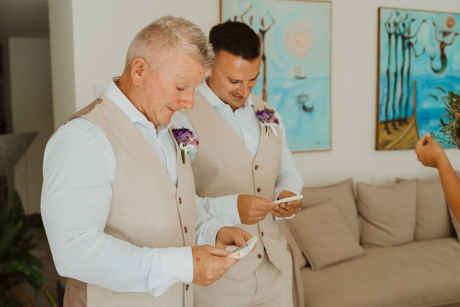 Wedding party members check their phones while waiting in formal attire.