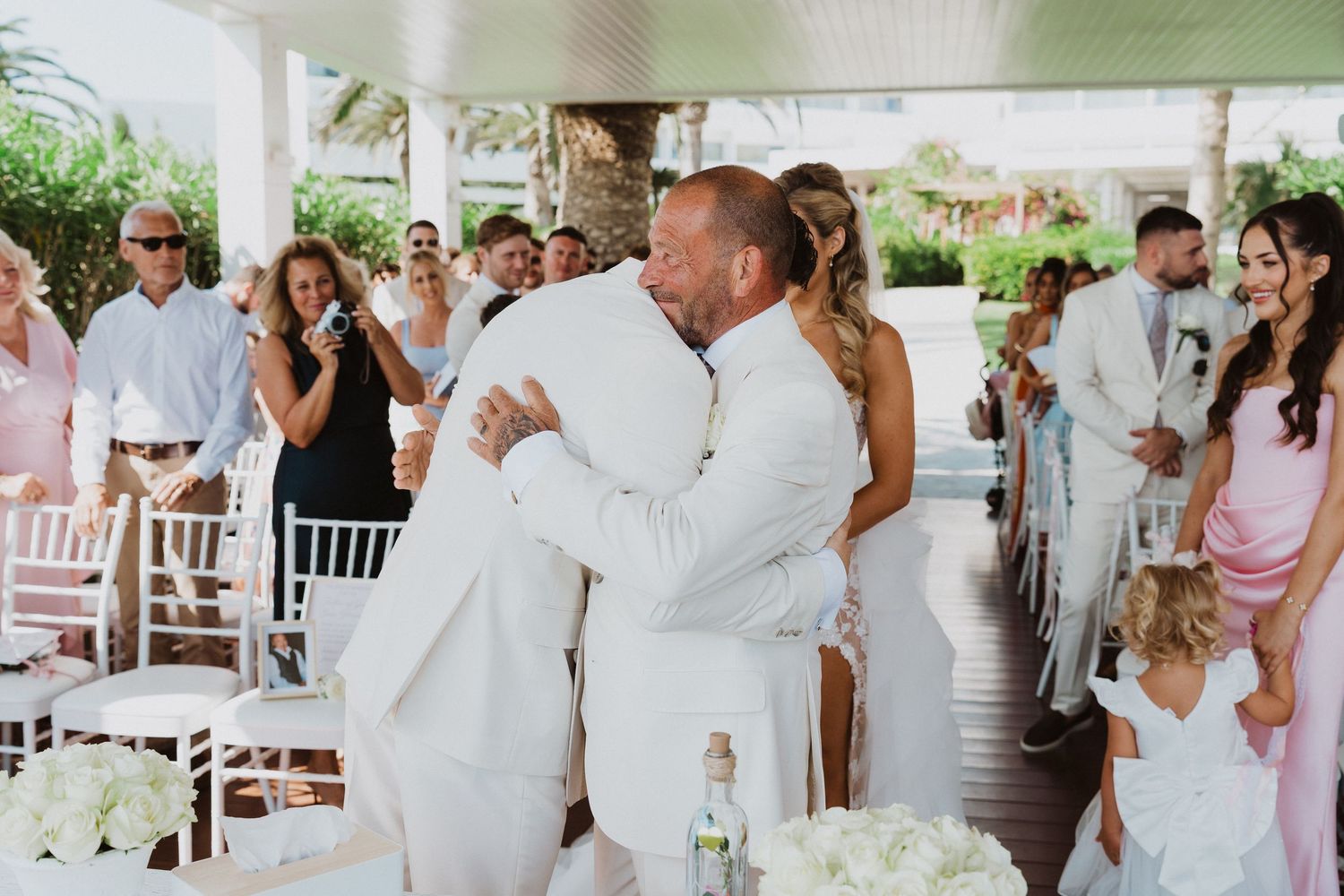 A collage of wedding reception photos showing dancing couples in white attire and guests celebrating at an outdoor venue.