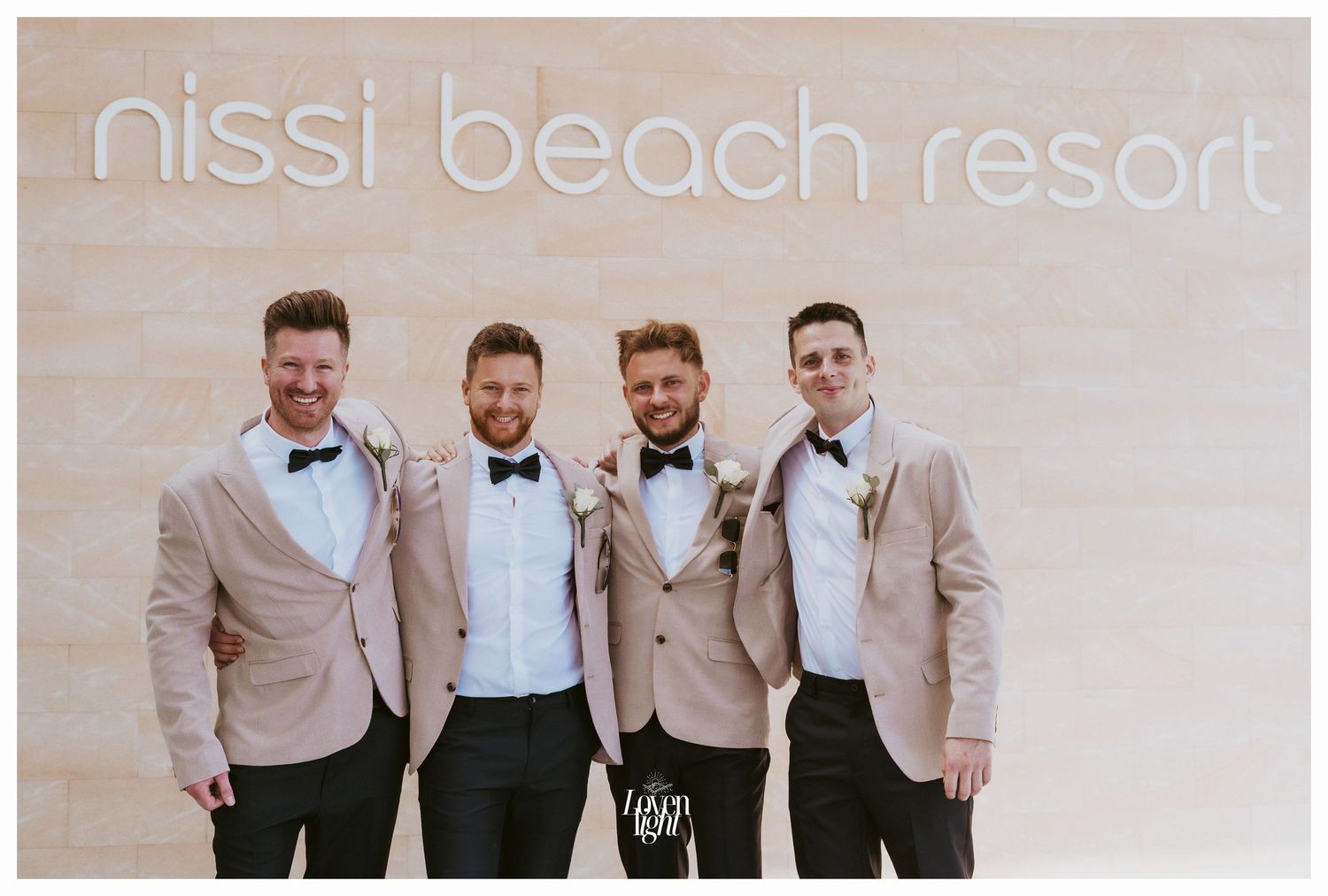 Wedding party members in coordinated beige jackets and bow ties at Nissi Beach Resort.