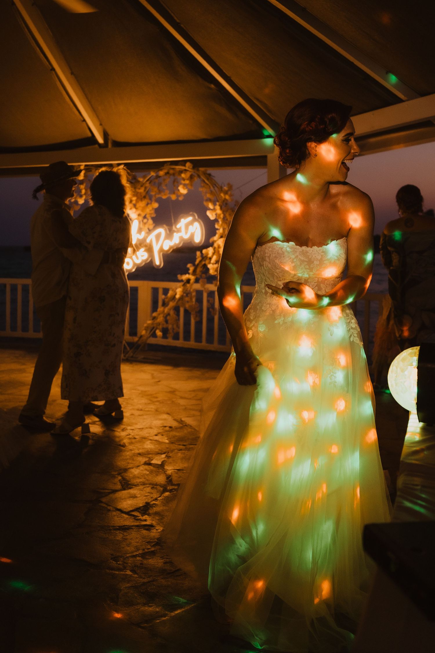 Wedding celebration with disco lights creating magical atmosphere on dance floor.