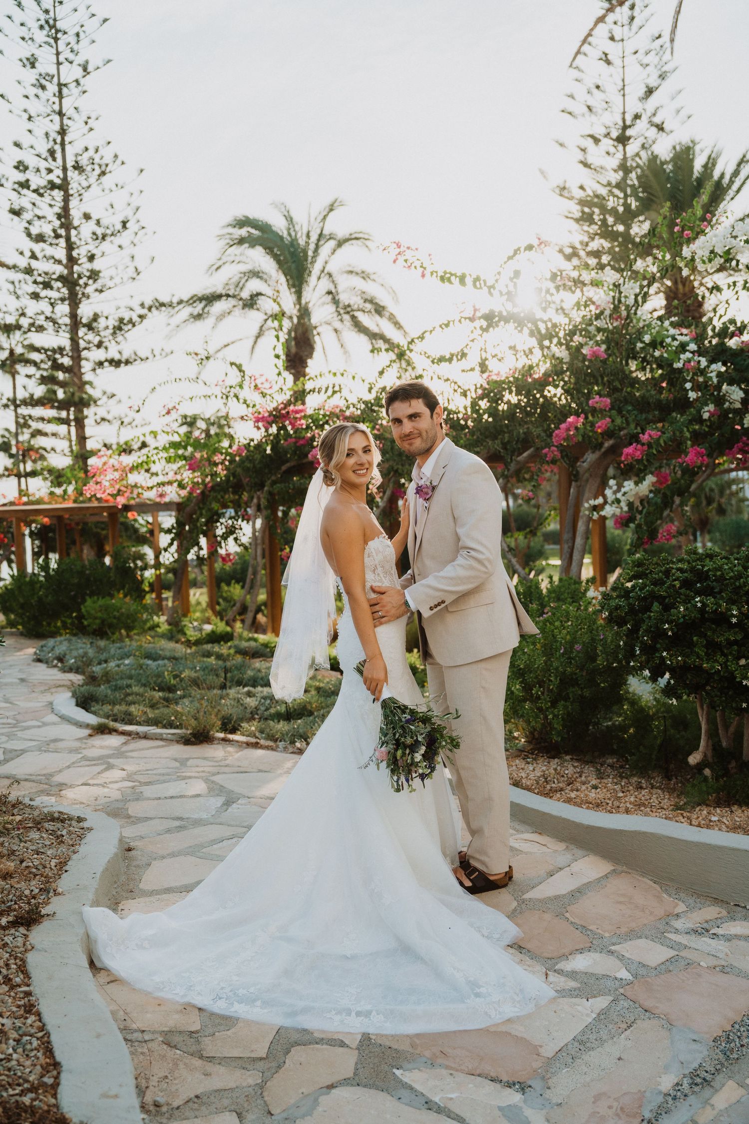 A romantic wedding dance captured on a stone path surrounded by tropical gardens.