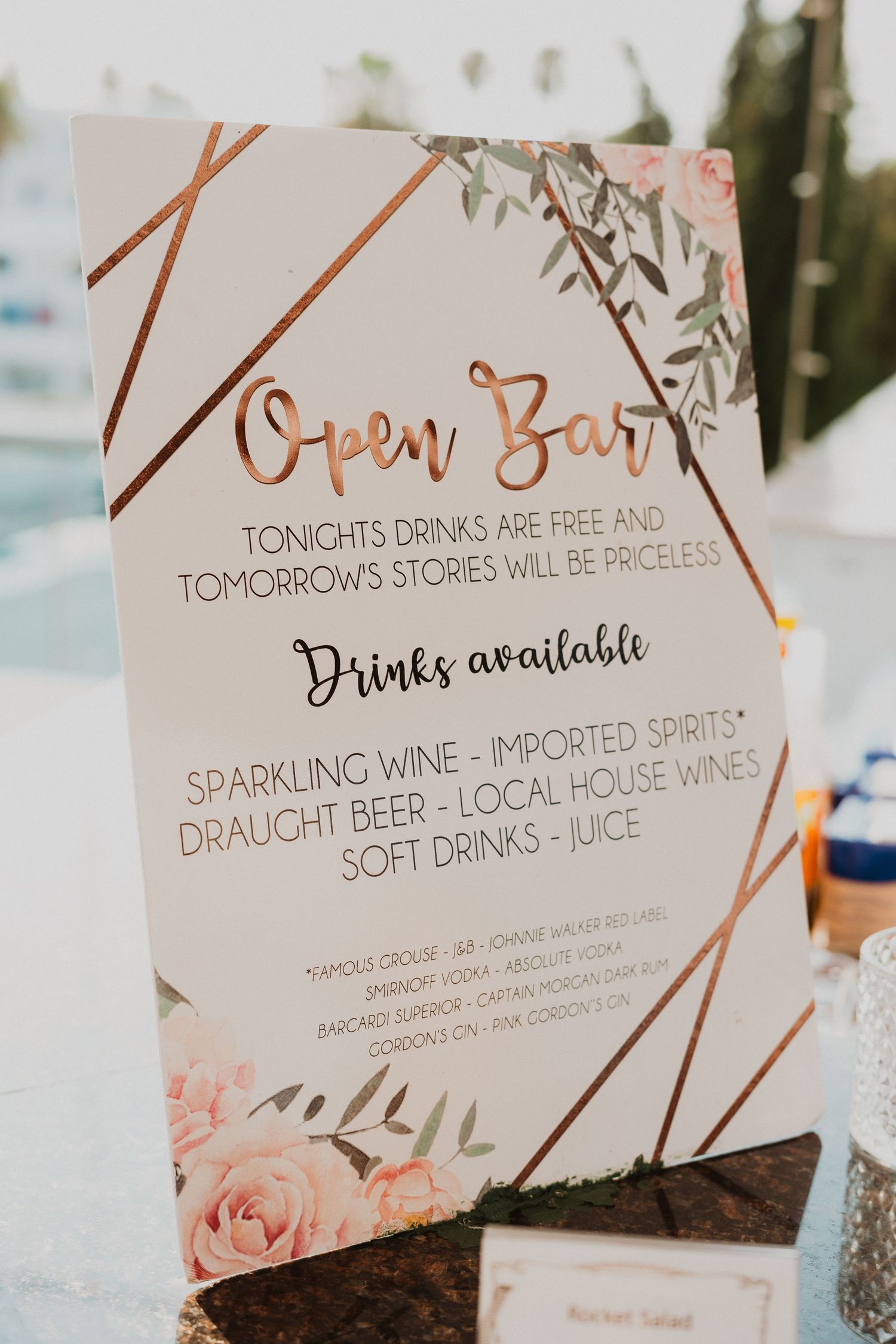Elegant open bar menu sign with rose gold geometric design and floral accents.