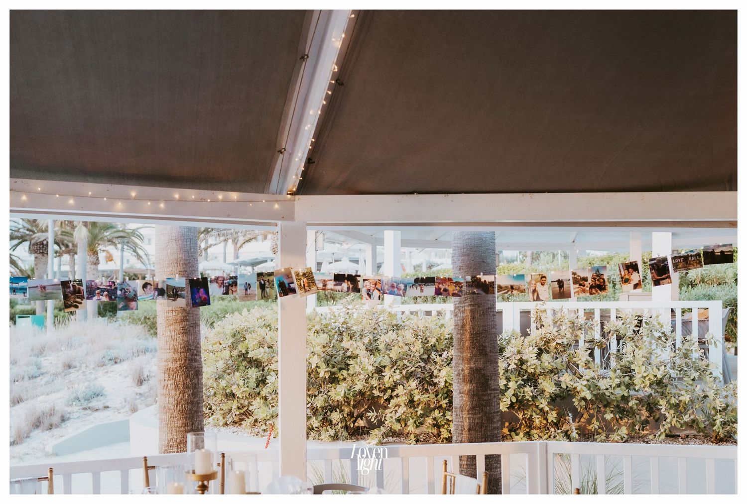 Light-filled wedding reception space with white decor and views of surrounding landscape.
