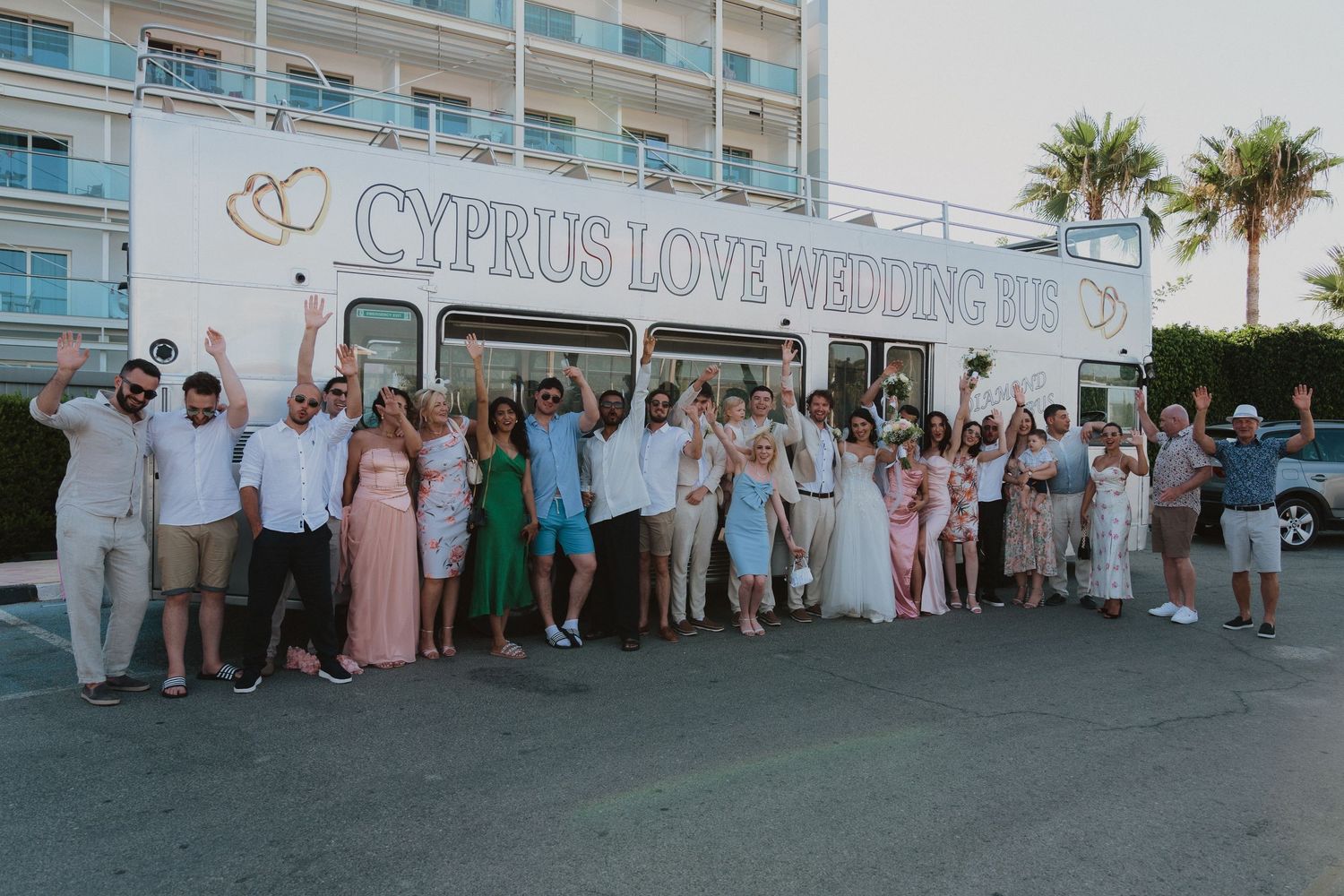 Wedding party group photo in front of Cyprus Love Wedding Bus.