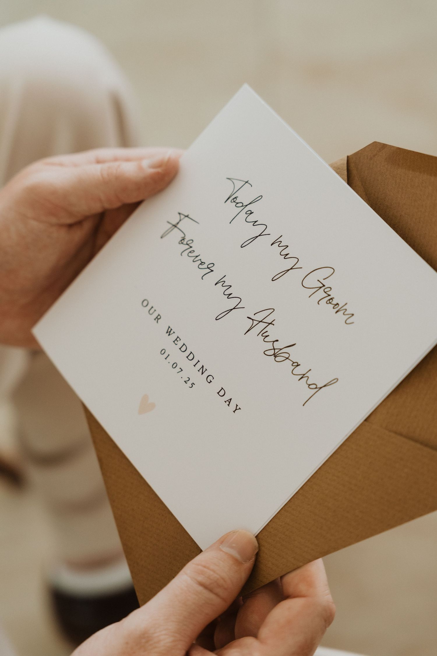 A series of handwritten thank you notes on white cards being held against a brown envelope background.