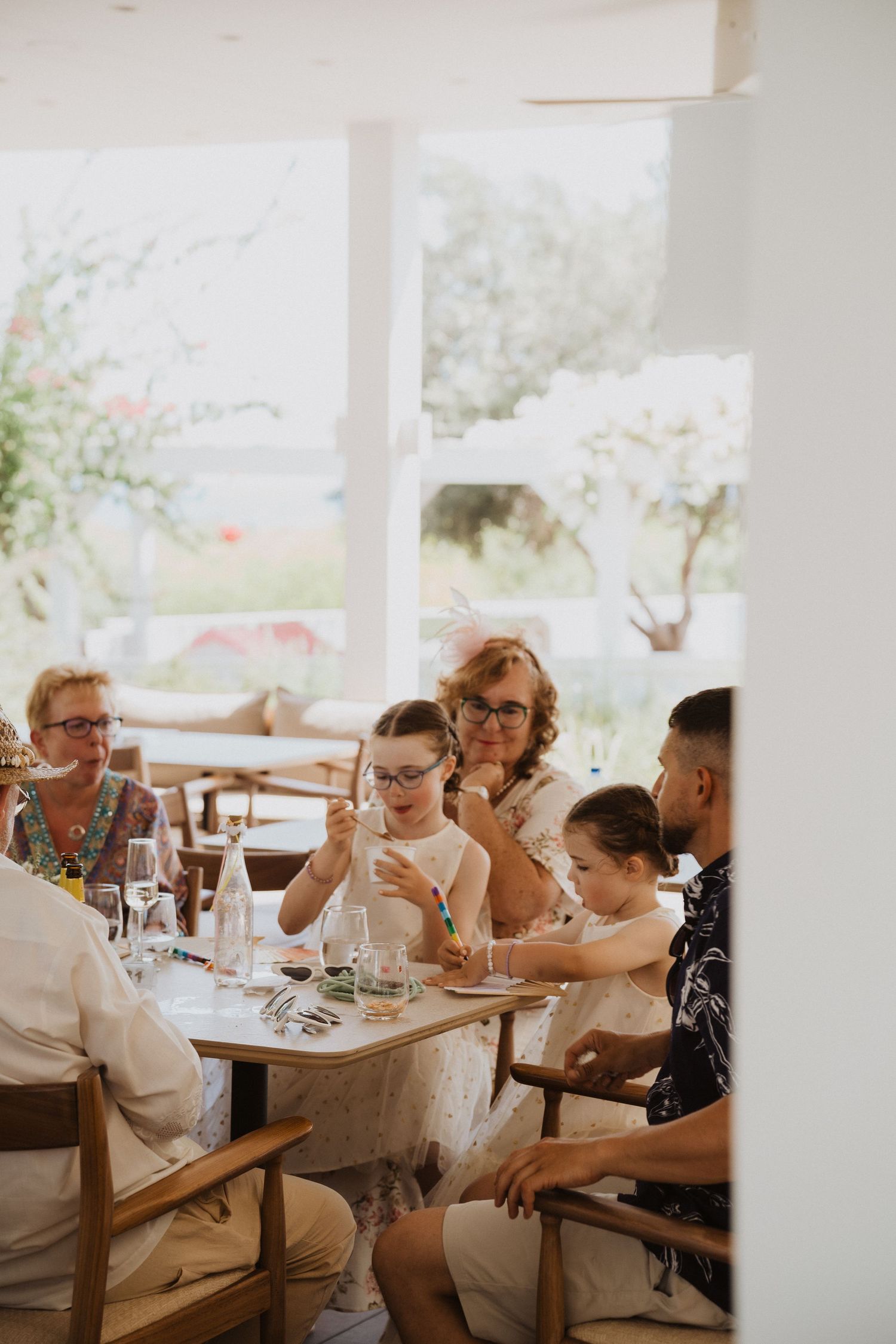 Guests enjoying a meal at an outdoor restaurant with natural lighting.