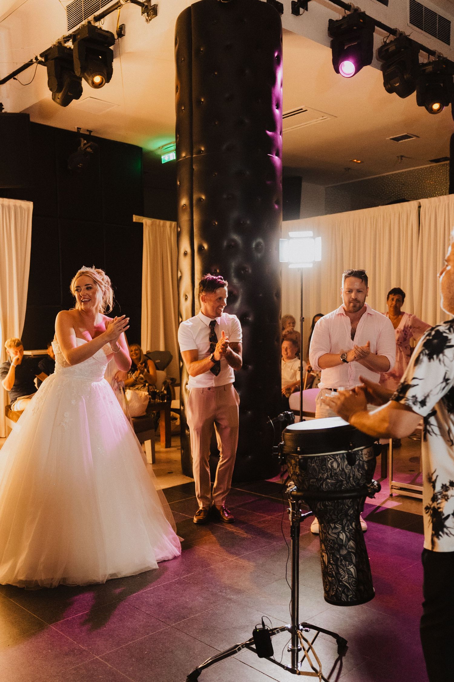 Wedding reception performers with drums creating entertainment for guests.