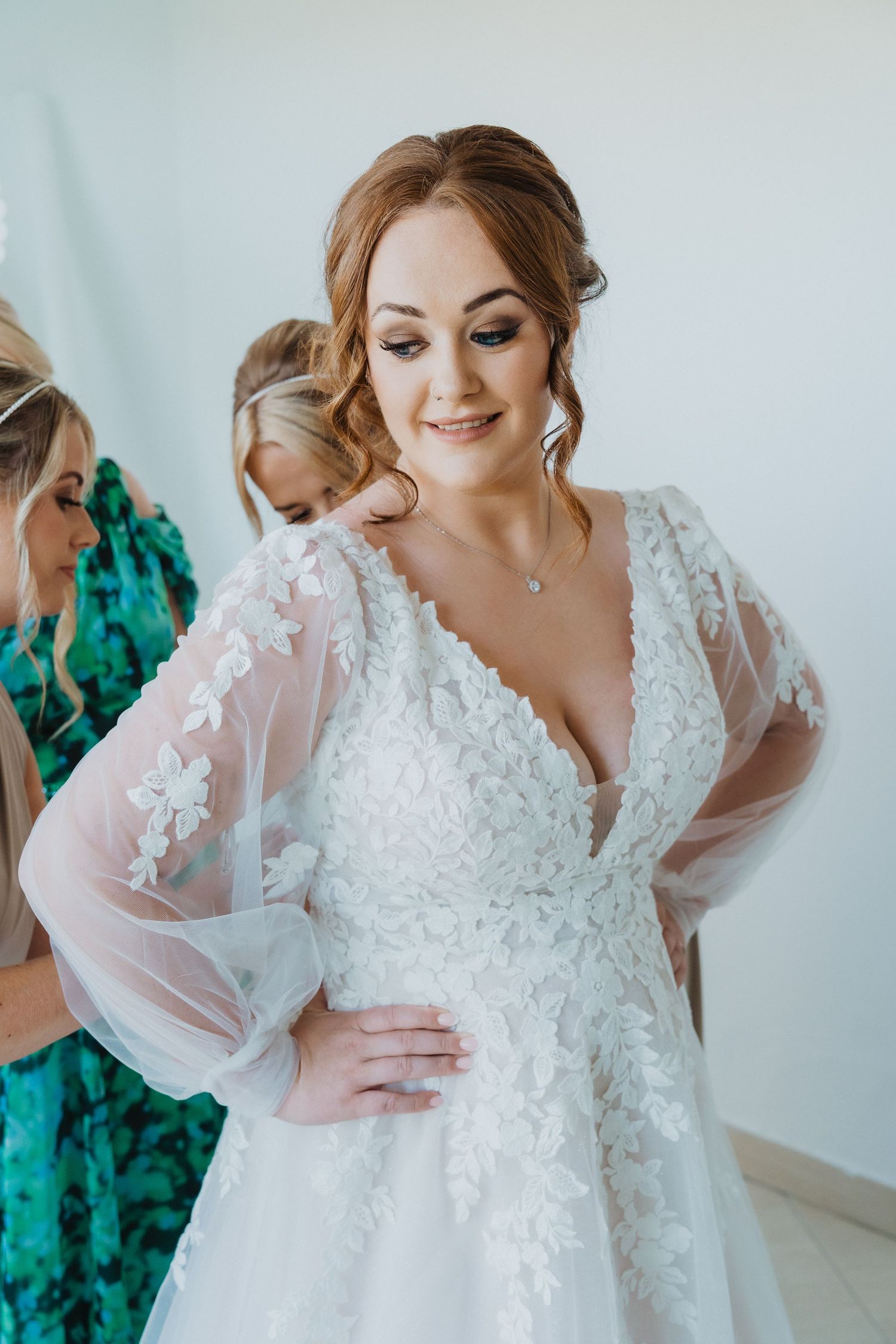 Close-up of detailed lace wedding gown with sheer bishop sleeves.