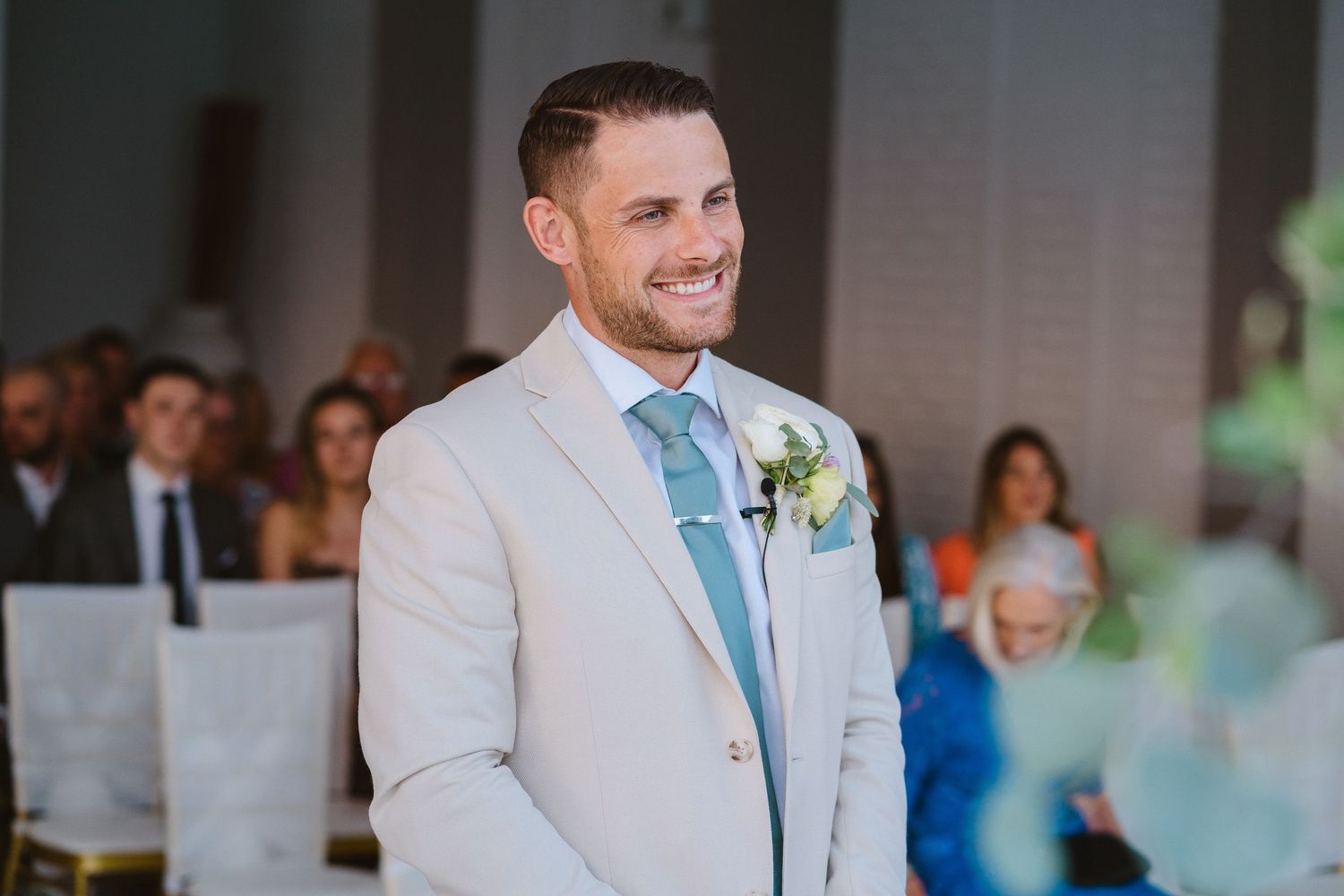 Formal wedding ceremony setting with guest seating and decorative elements.