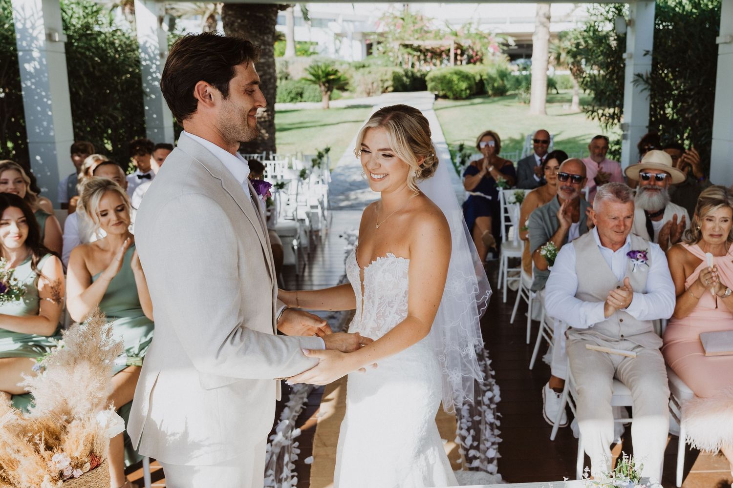 Panoramic sequence of a wedding celebration showing multiple moments under a covered patio.