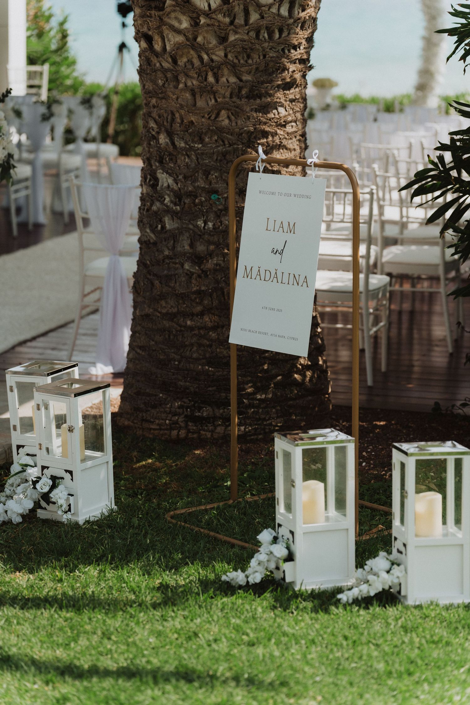 Elegant outdoor wedding sign for Liam and Madalina with lanterns and floral decor.