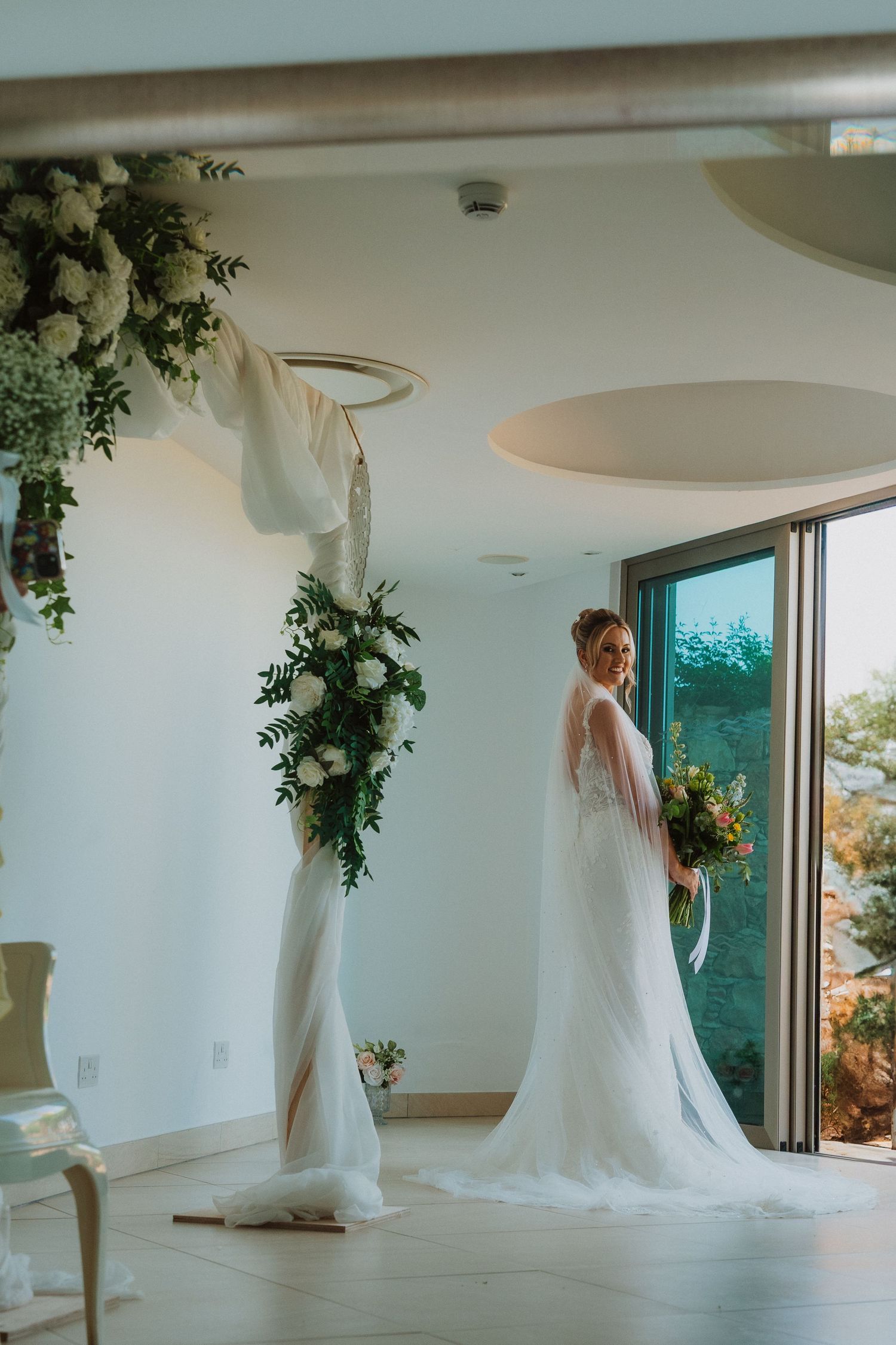 A sequence of photos showing a bride in a flowing white wedding dress moving gracefully in a bright modern room.