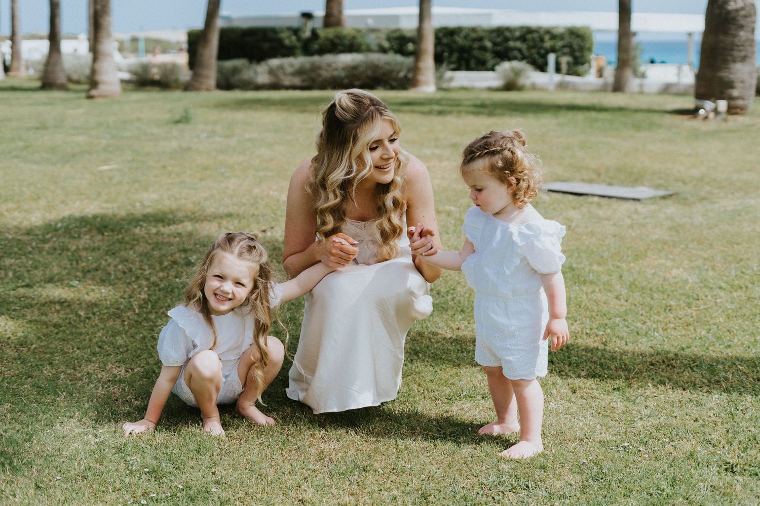 Candid moment on a sunny lawn with white summer outfits.