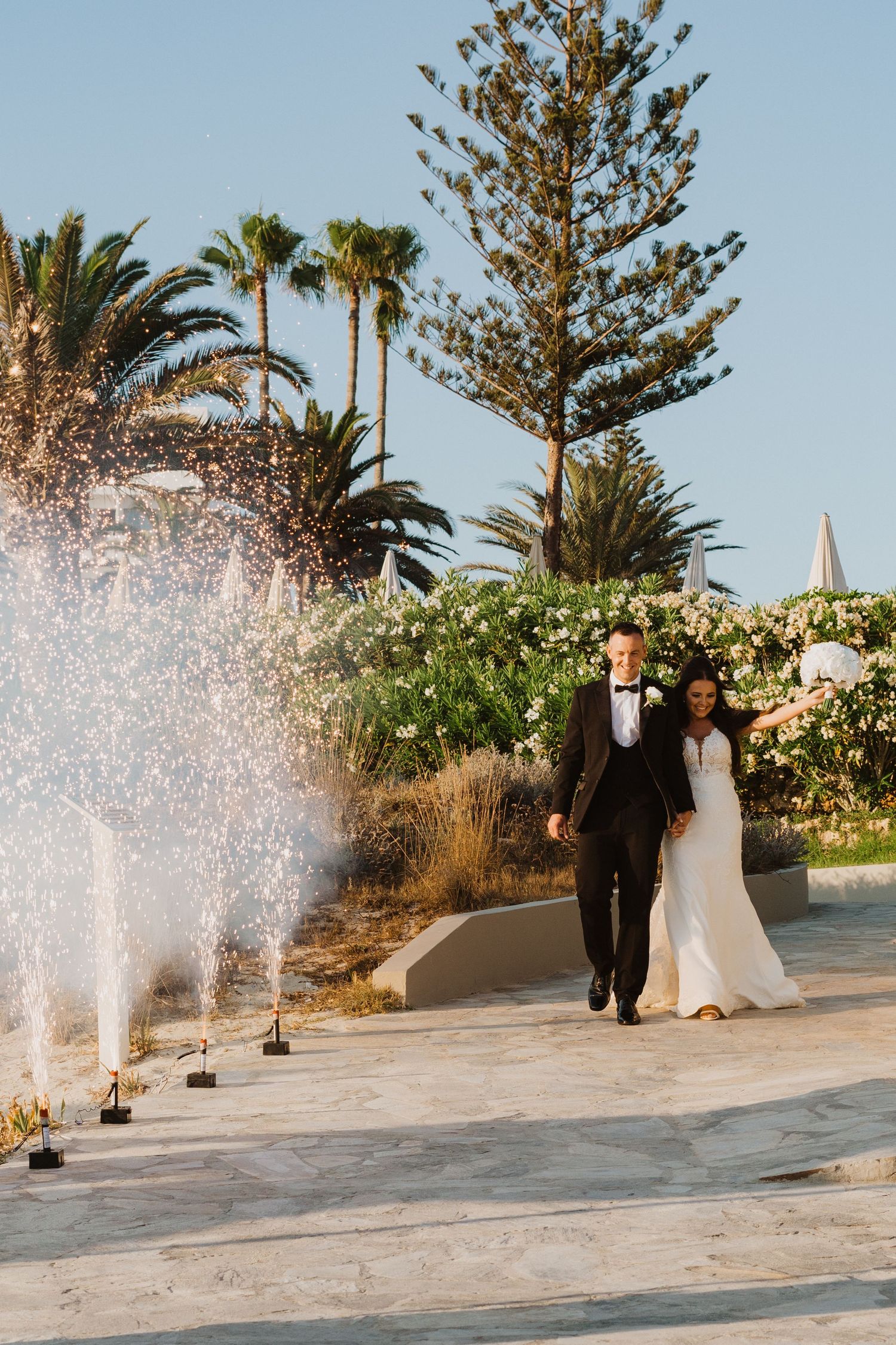 Wedding ceremony location with decorative water fountains and tropical landscaping.