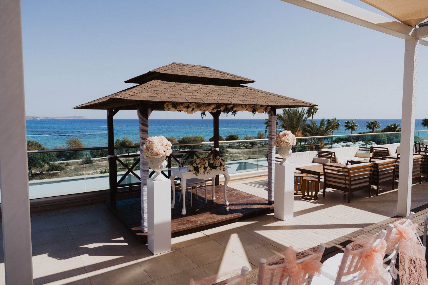 Beachfront wedding venue with covered terrace and panoramic ocean views.