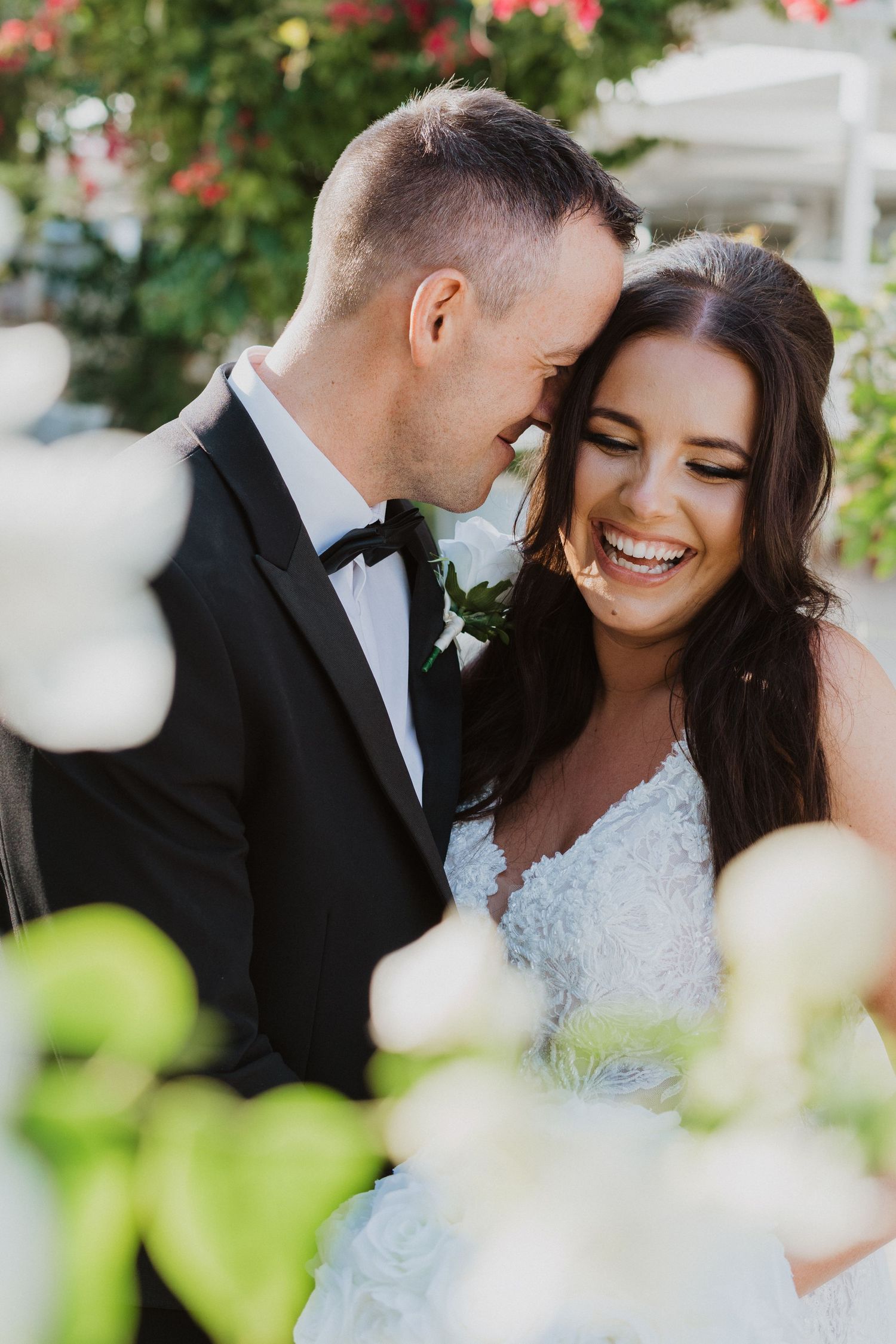 Romantic wedding portraits captured in a lush garden setting with soft natural light.