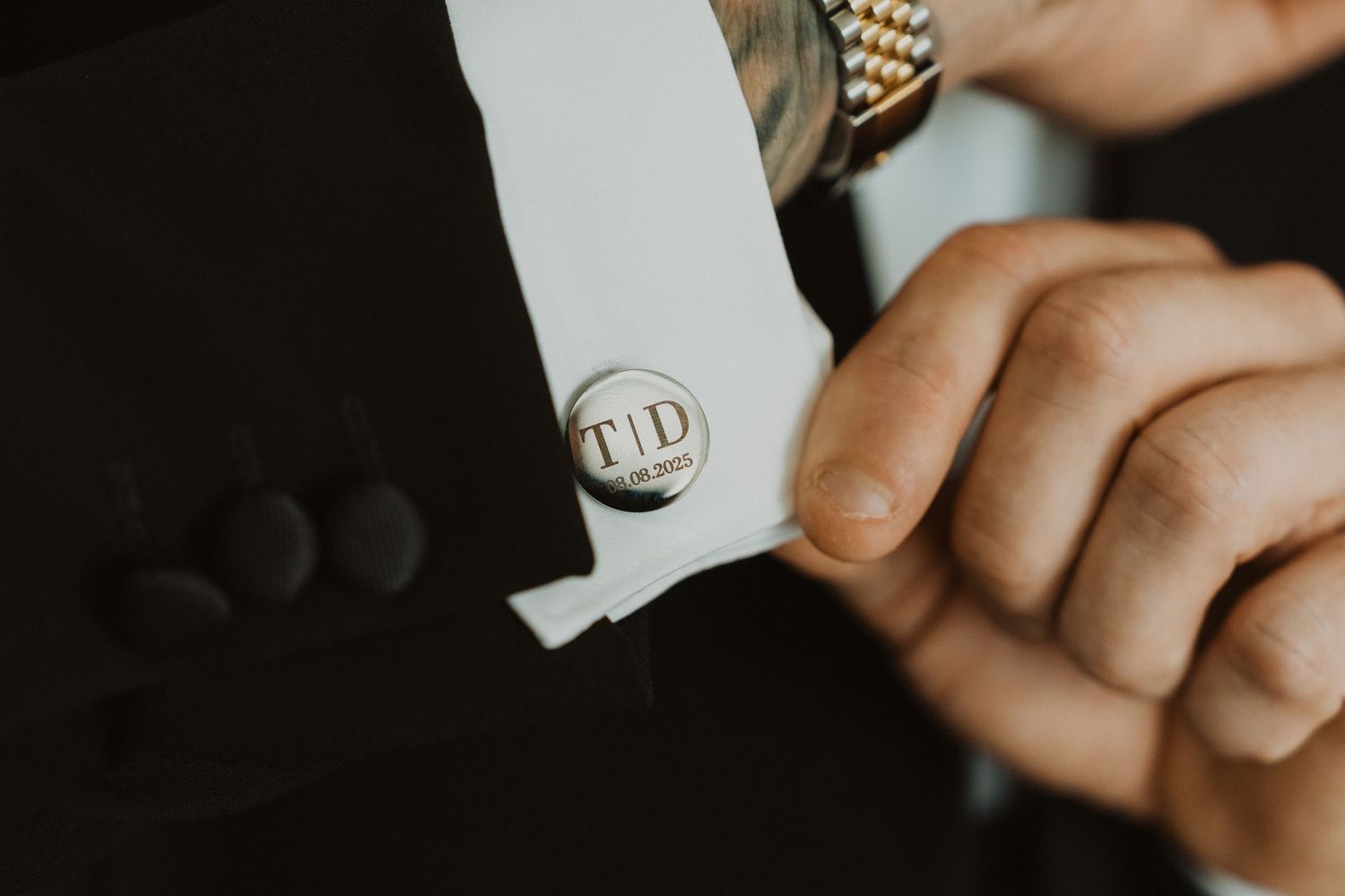 A gold Rolex watch with jubilee bracelet is displayed on a dark background.
