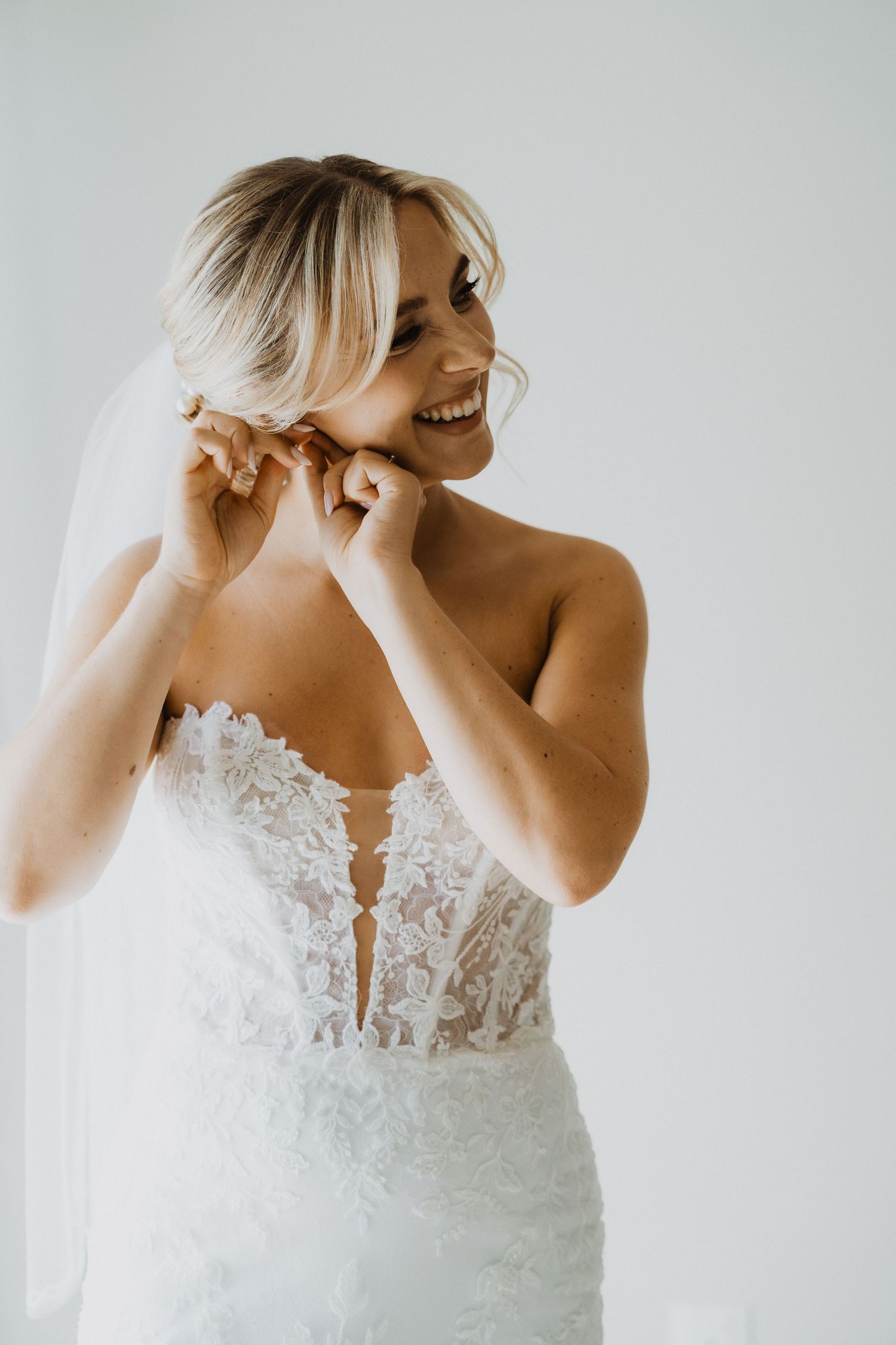 Close-up details of a delicate lace wedding dress bodice with sheer elements.