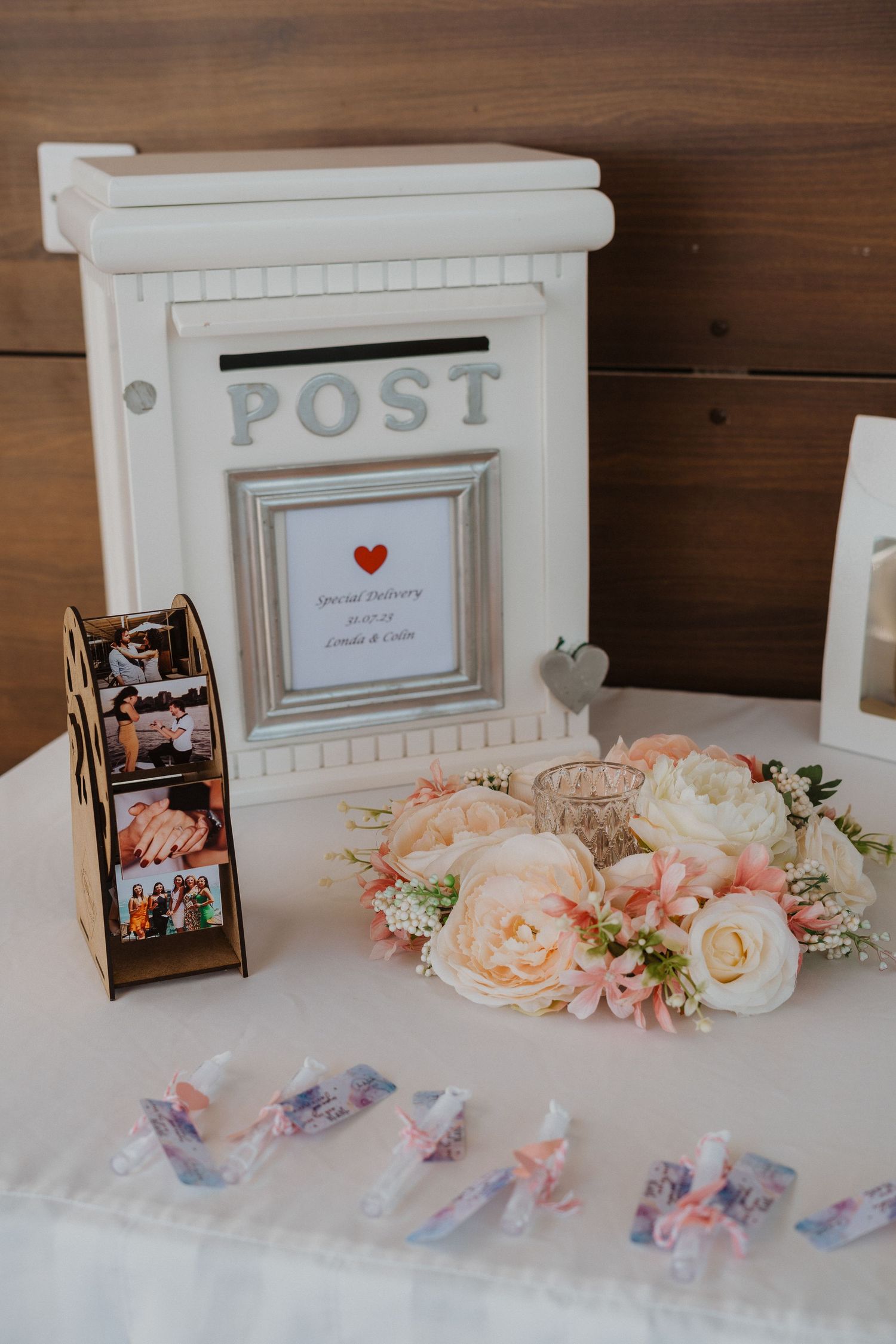 Decorative white post box card holder with floral crown and pink roses for wedding cards.