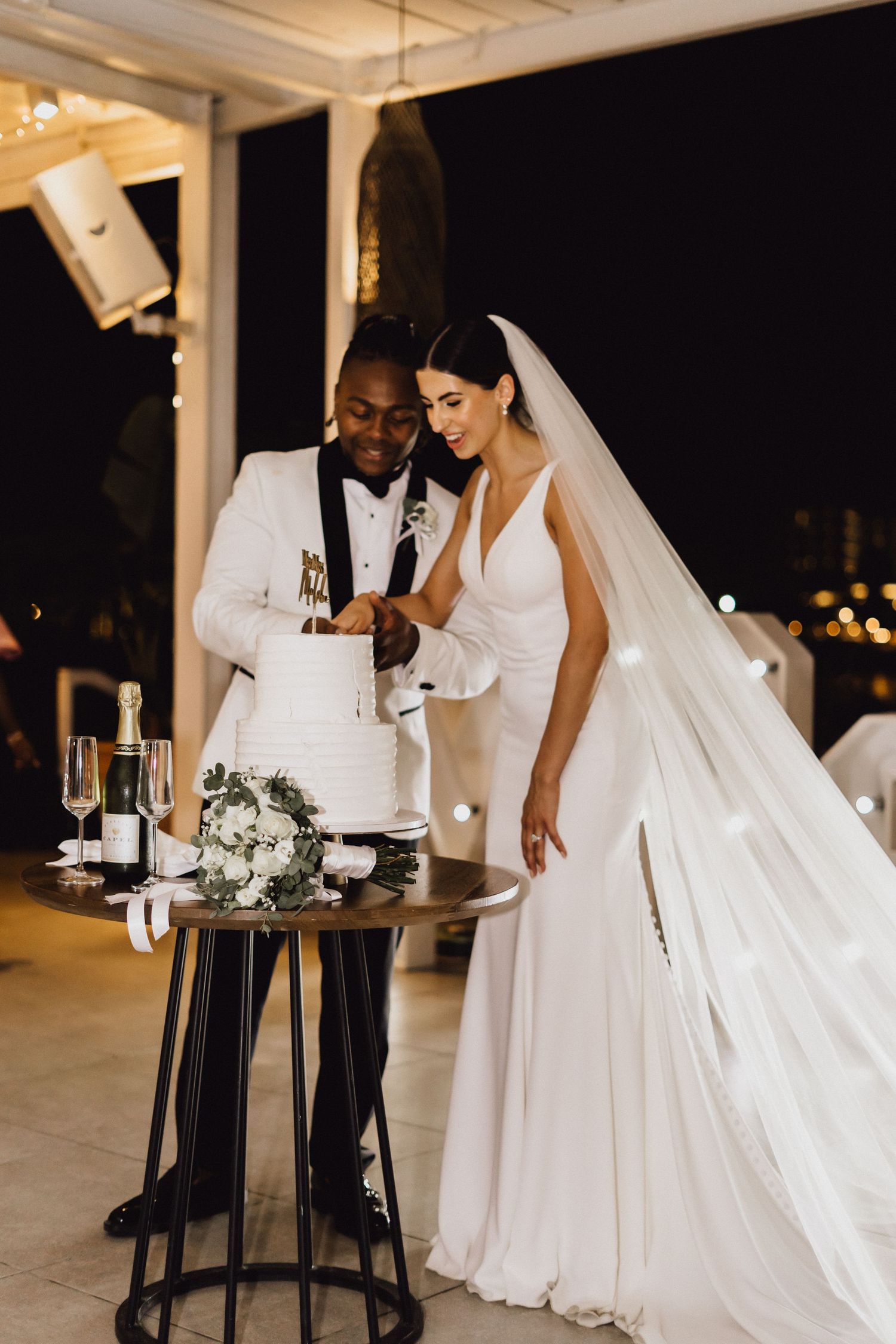 A couple sharing an intimate moment during their wedding cake cutting ceremony.
