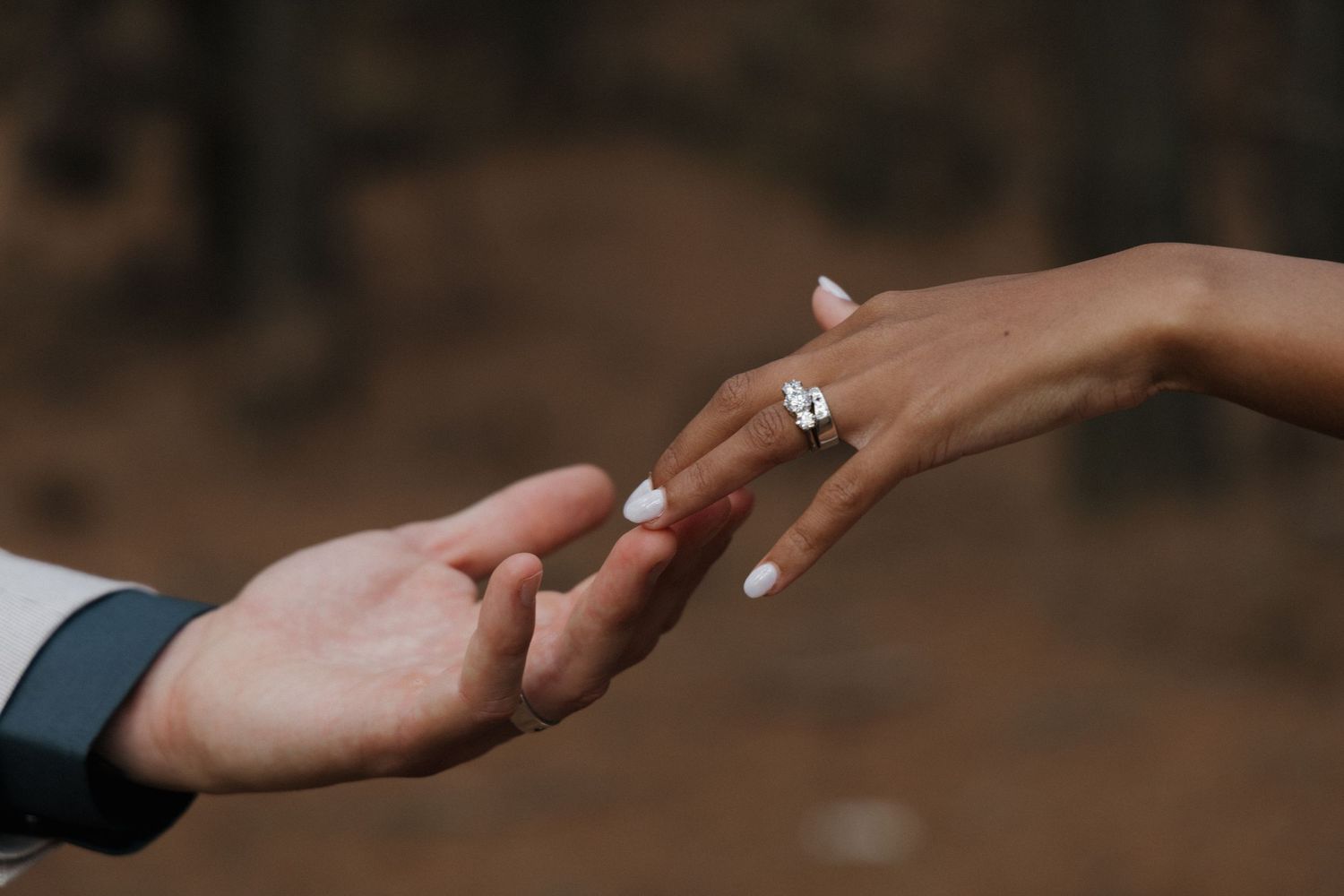 bride and groom hands touching each other to show off their rings