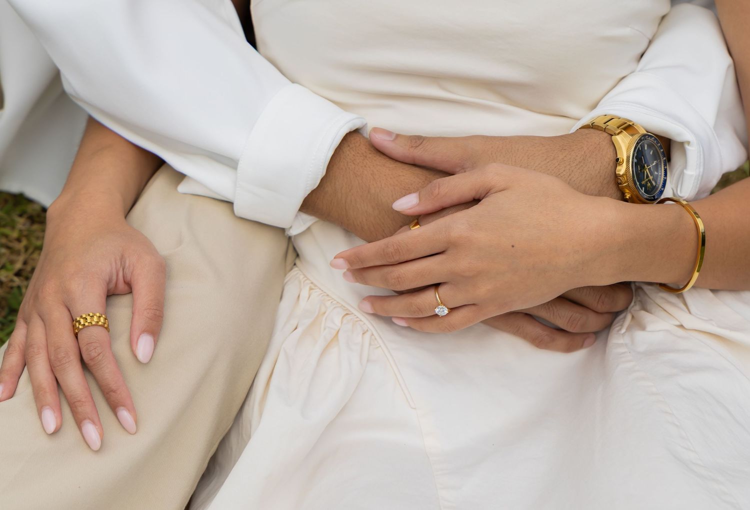 Close up of engaged couple of their rings and hands