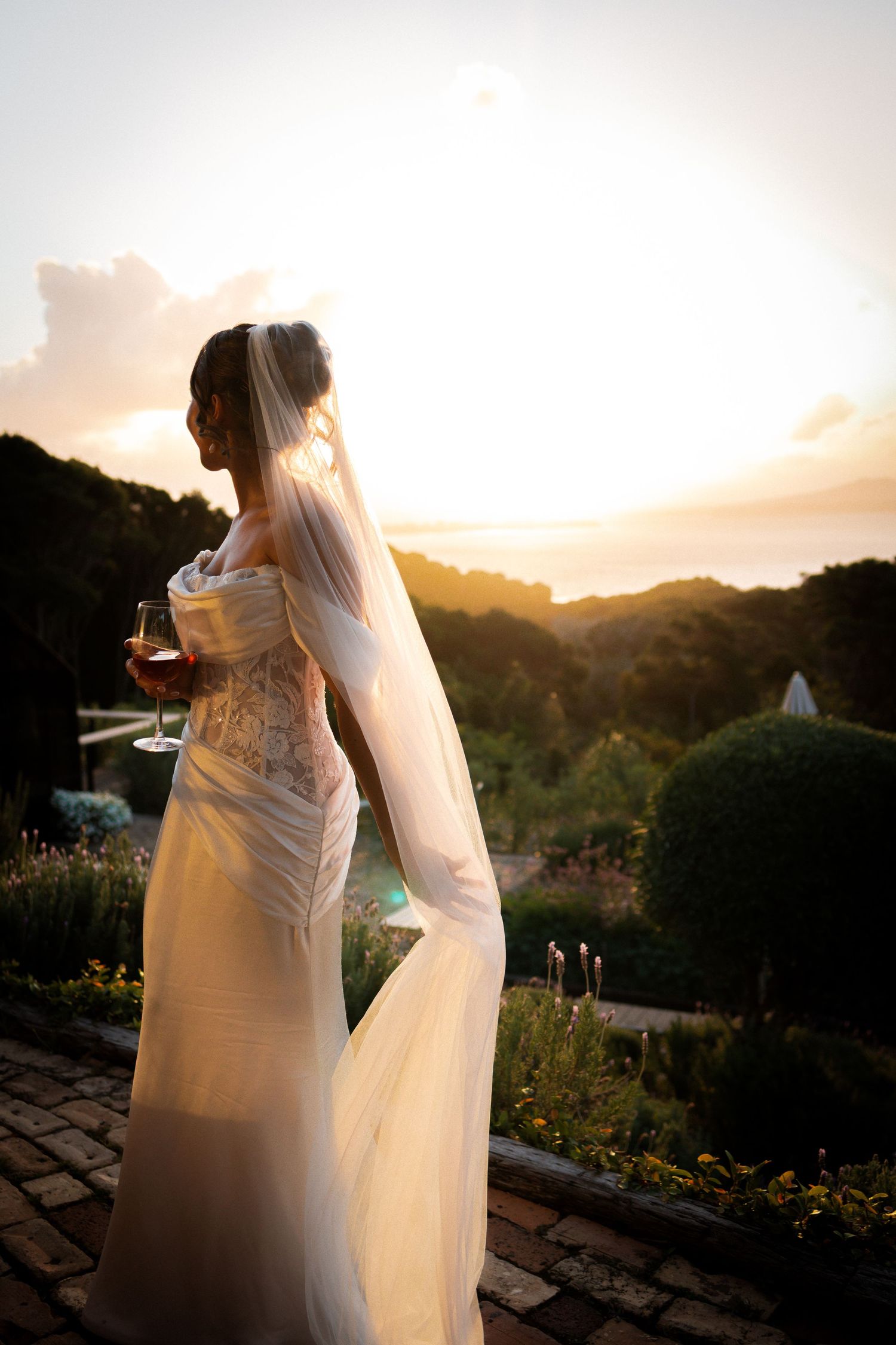 Bride in golden hour highlighting her beautiful  dress and veil