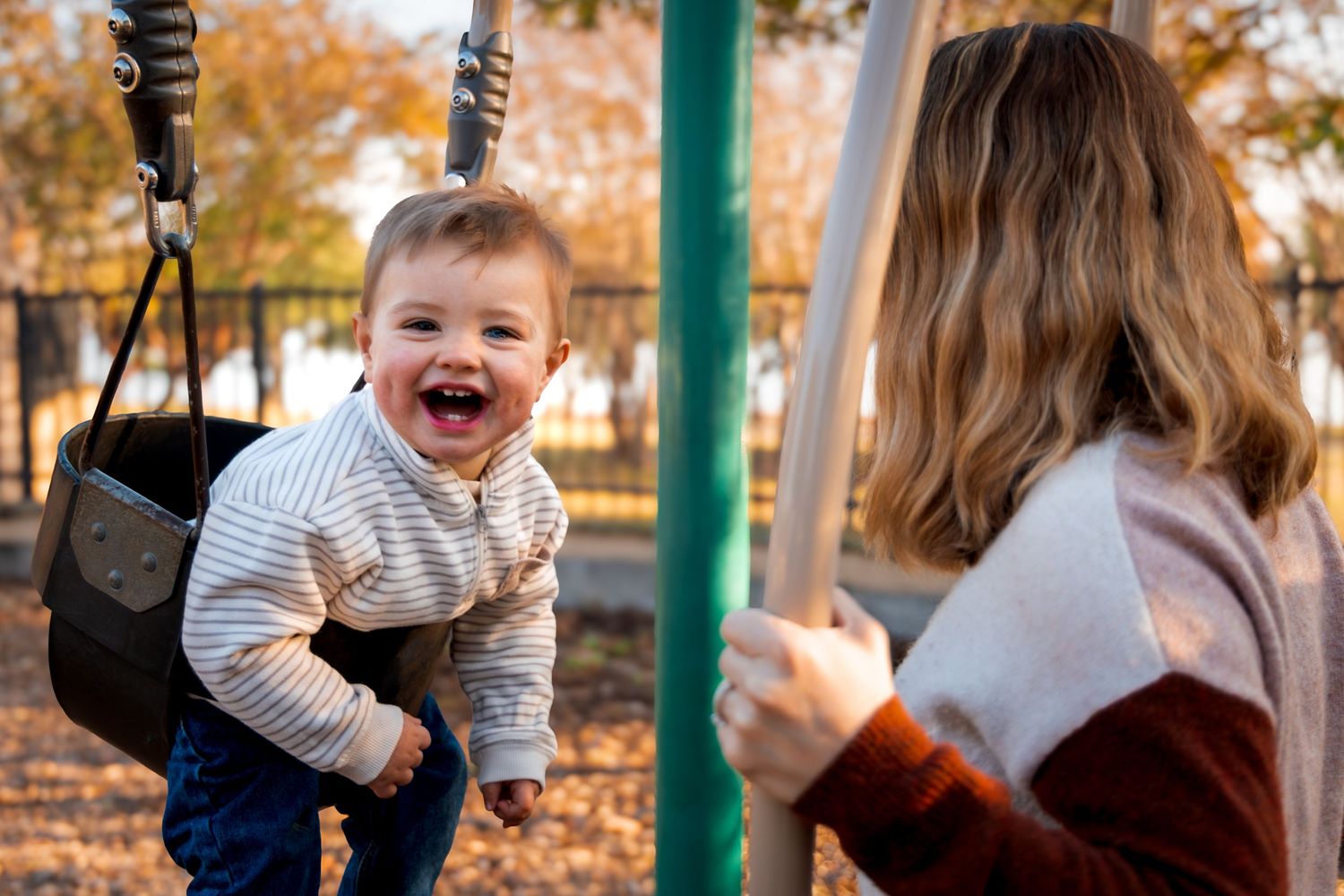 Mom and son playing during outdoor portrait session in Dallas