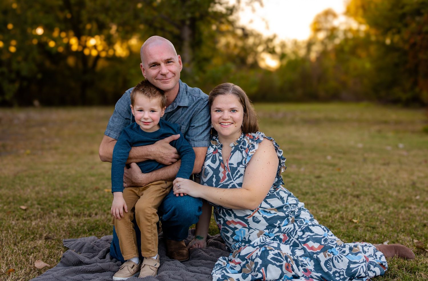 Family smiling during portrait session in McKinney TX
