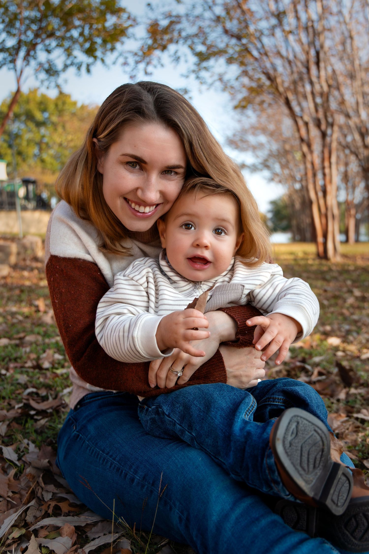 Mom and son snuggling and smiling during fall session in DFW