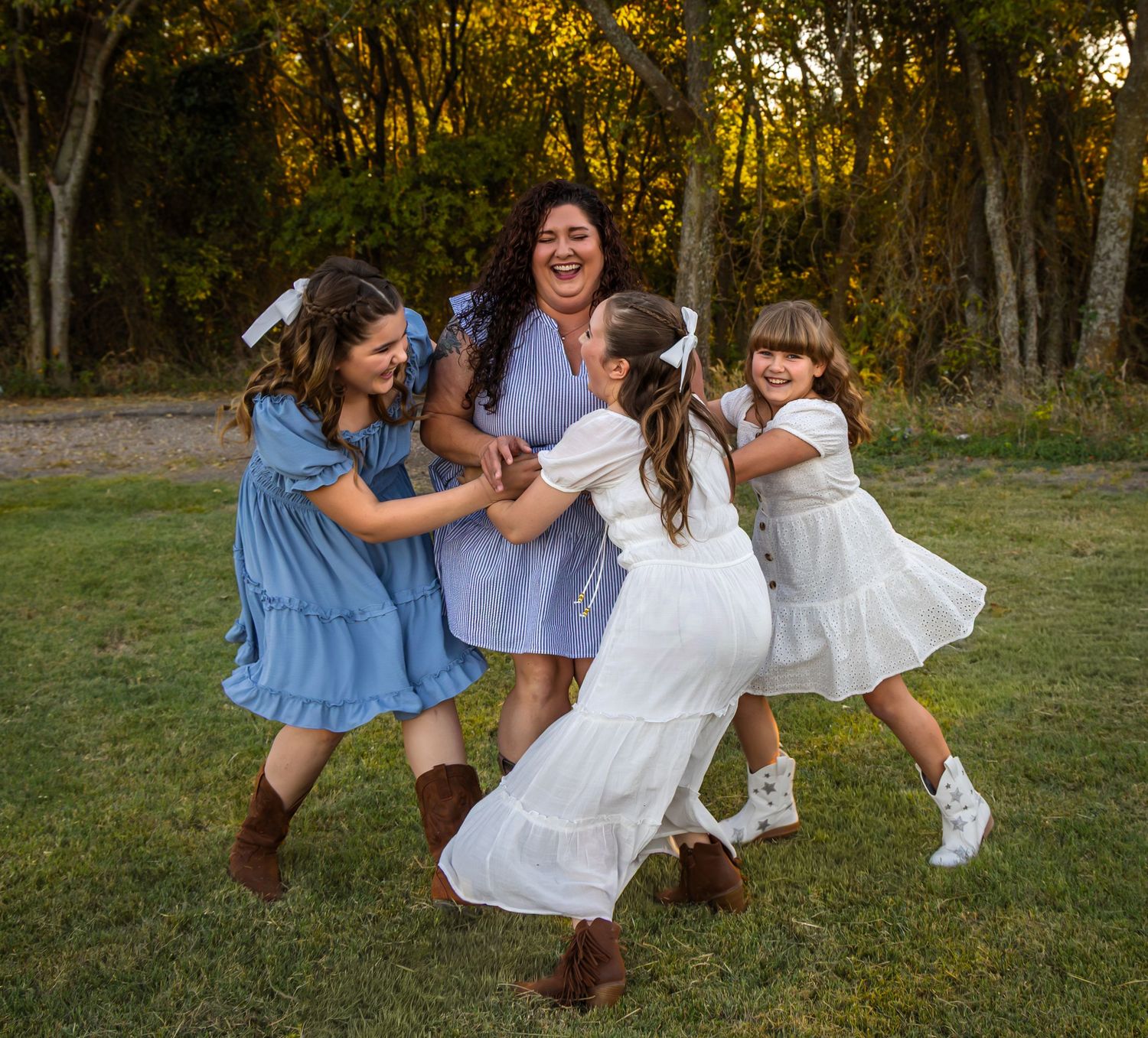 Family smiling during portrait session in Parker TX