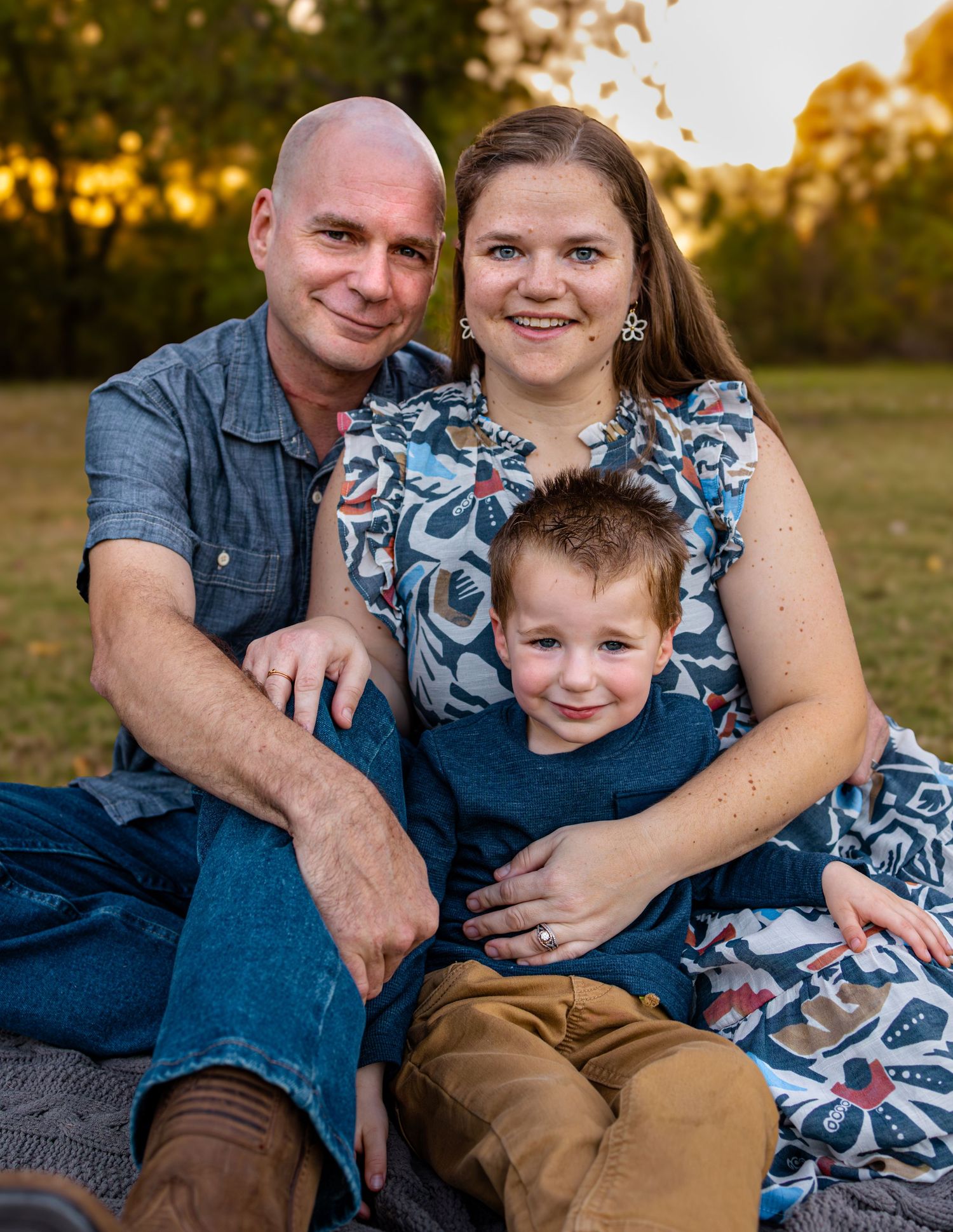 Family  smiling during portrait session in McKinney Texas