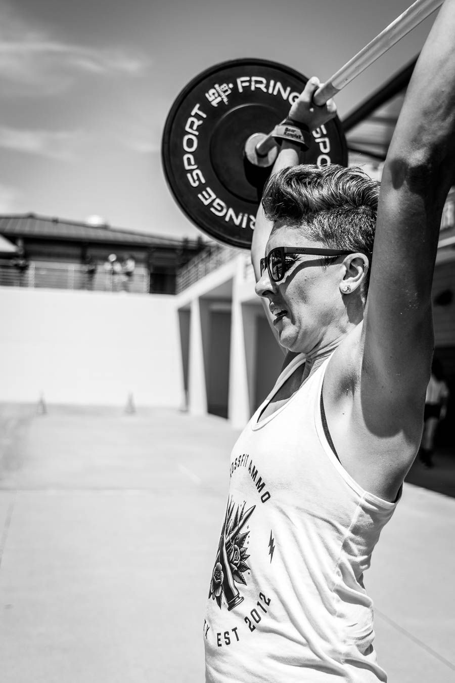 Athlete performing barbell lift during Texas Heat fitness competition