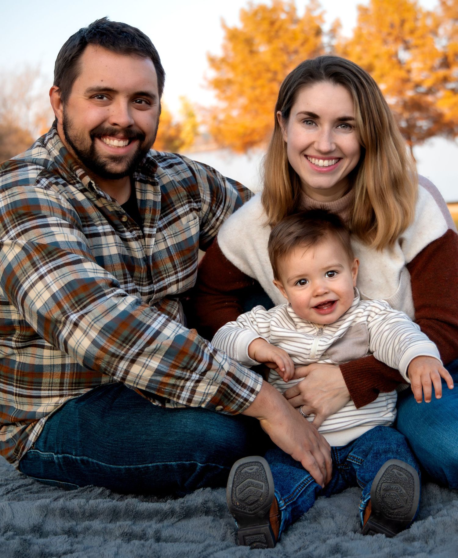 Family smiling during outdoor fall session in DFW