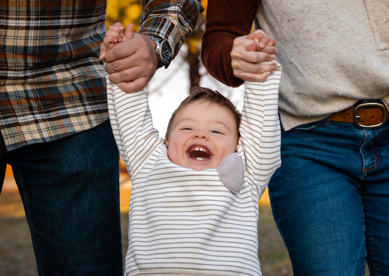 Child laughing during outdoor family session in DFW