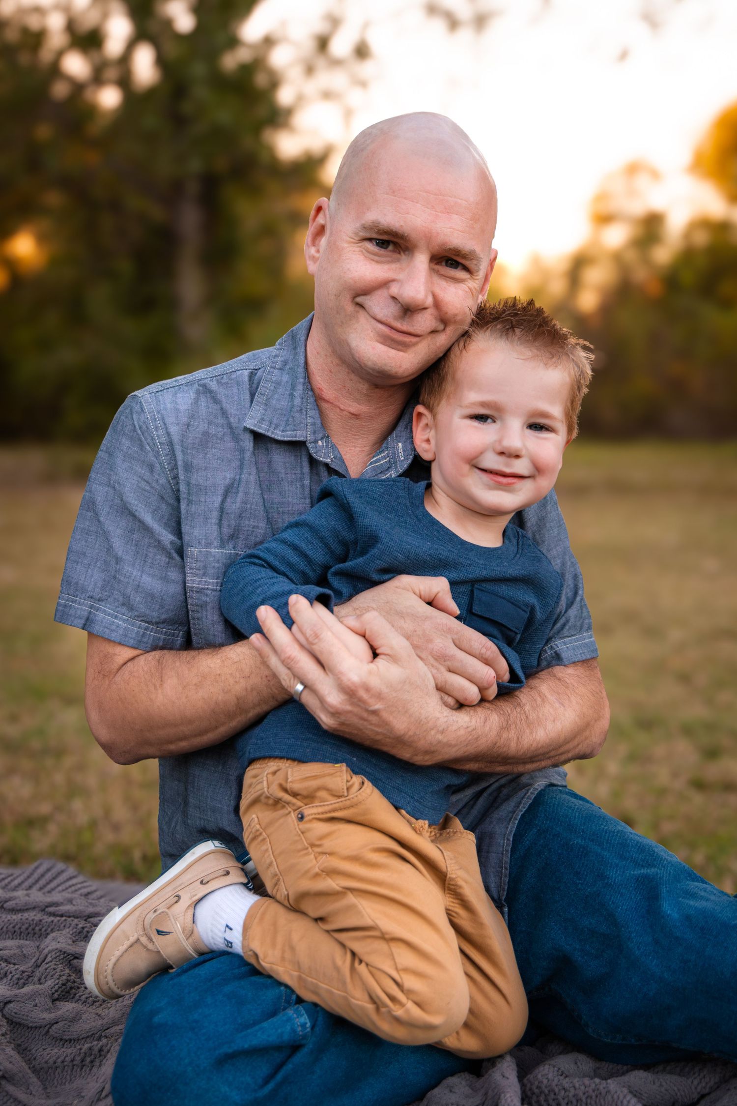 Father and Son smiling during portrait session in McKinney Texas