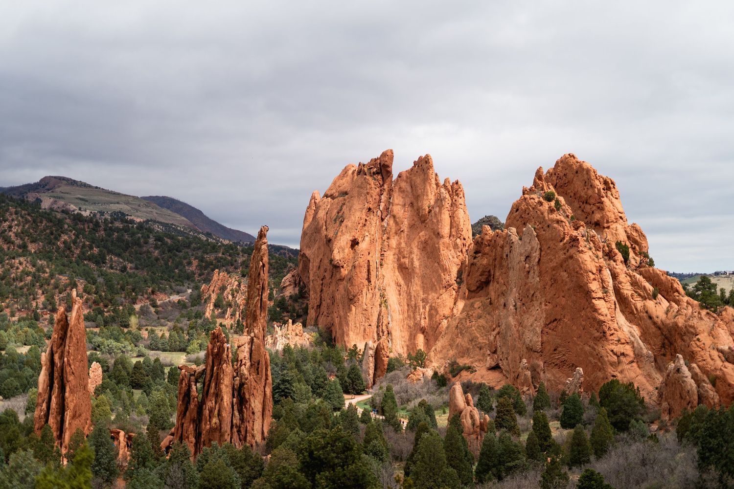 Dramatic red sandstone rock formations at Garden of the Gods Colorado under cloudy sky.