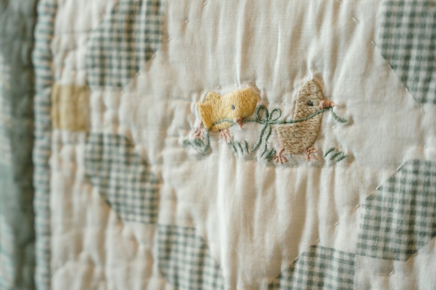 Little chicks embroidered into a baby boy's newborn quilt.
