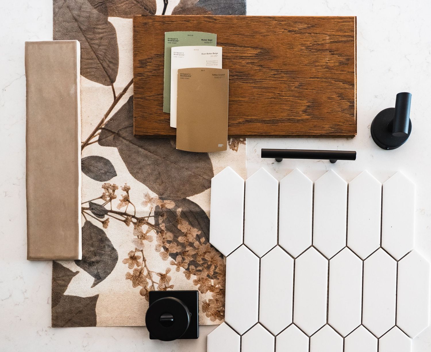 Interior design mood board featuring wood, tile, and fabric samples in warm brown and white tones.