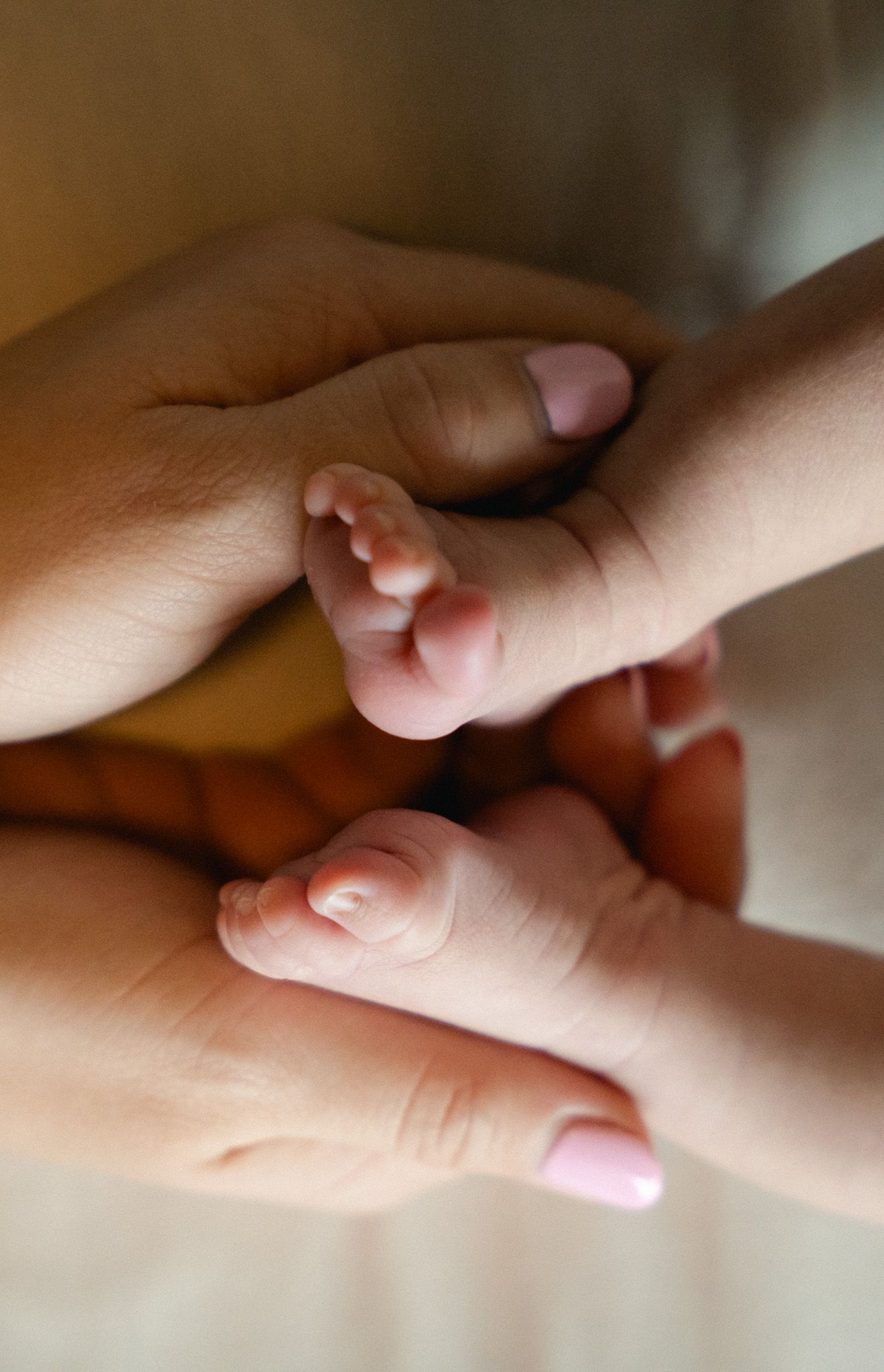 Mother holding her baby's feet in her hands.