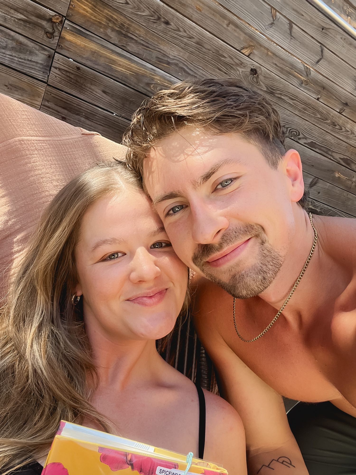 Happy couple relaxing outdoors on a sunny day at a Texas glamping destination.