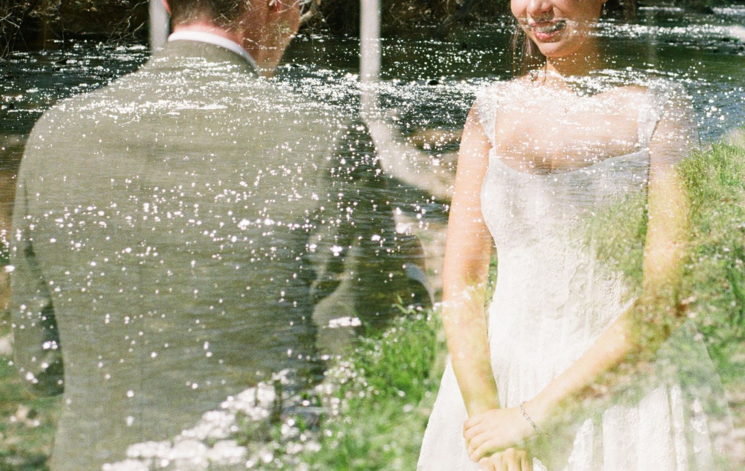 Dreamy double exposure photo of bride and groom surrounded by soft bokeh lights in an outdoor setting.