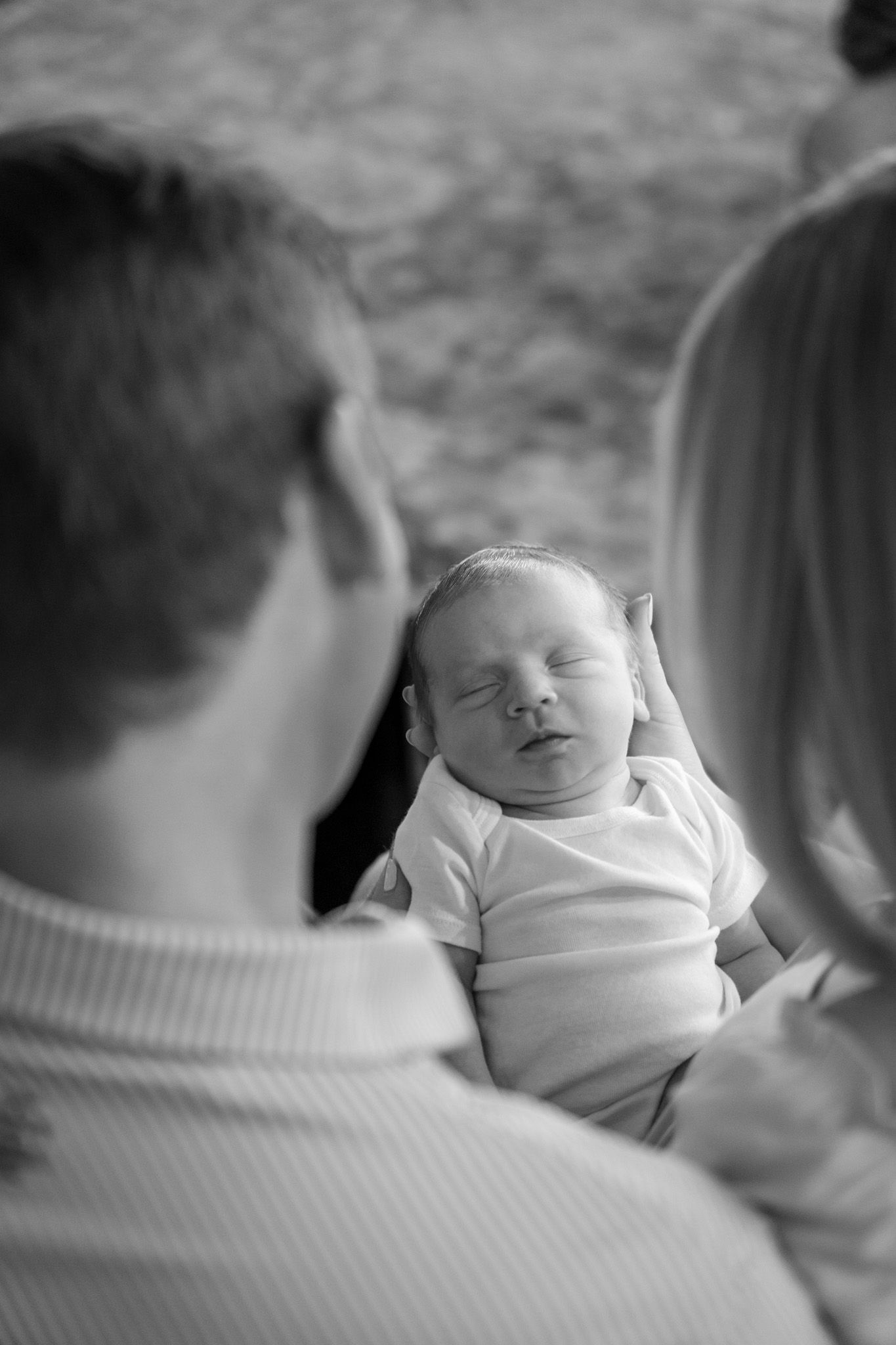 Parents holding her newborn son during an in-home session in East Bernard, Texas.