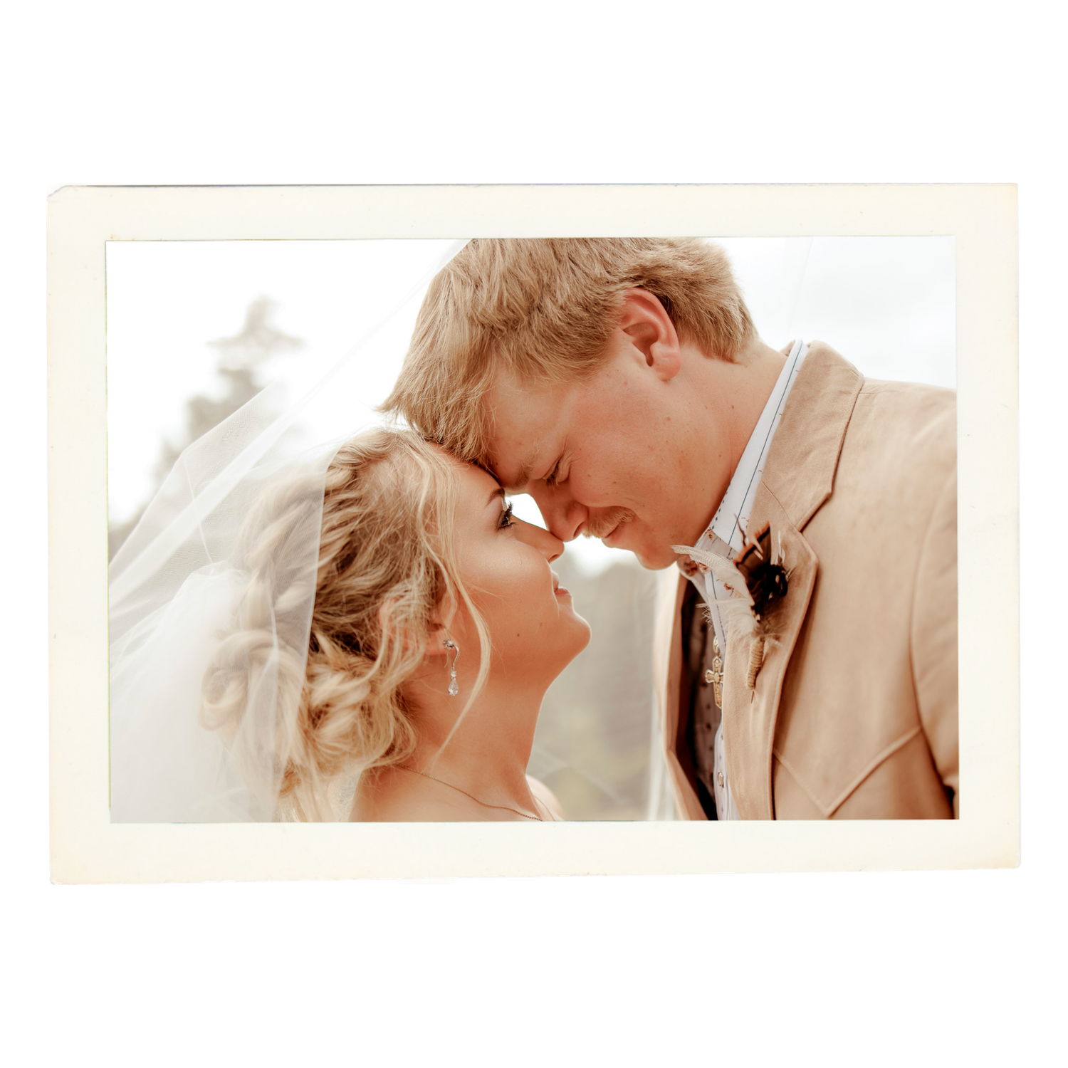 Romantic wedding couple sharing intimate moments in soft lighting and elegant attire.