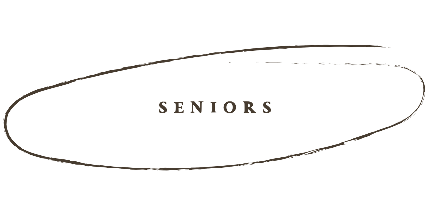 Vintage black and white yearbook photo showing a row of students in formal attire against a plain background.