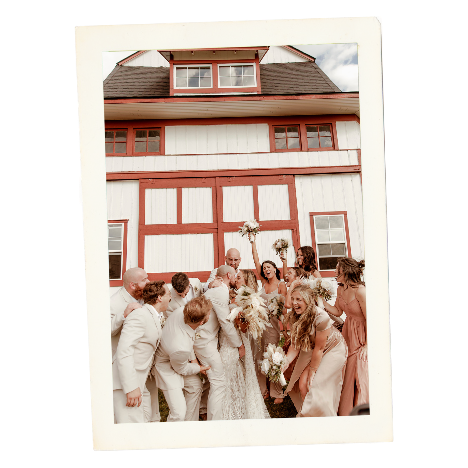 Wedding party poses together outdoors in white and beige attire for a group photo celebration.