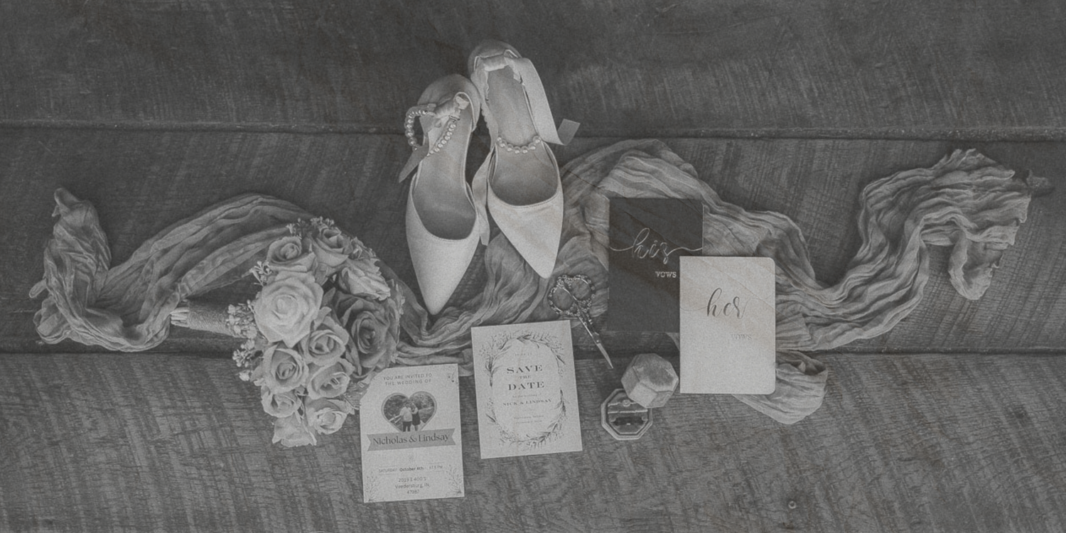 Black and white photograph showing a series of personal items and objects arranged in a row on the ground.