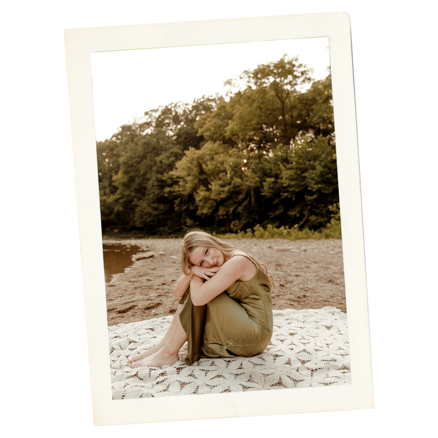 Person lounging on a sandy beach wearing casual clothing in a relaxed pose during a sunny day.