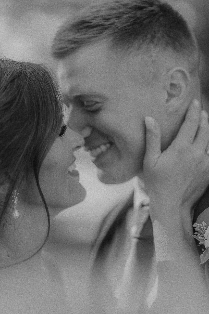 A romantic black and white photo series showing an intimate couple sharing tender kisses and embraces.